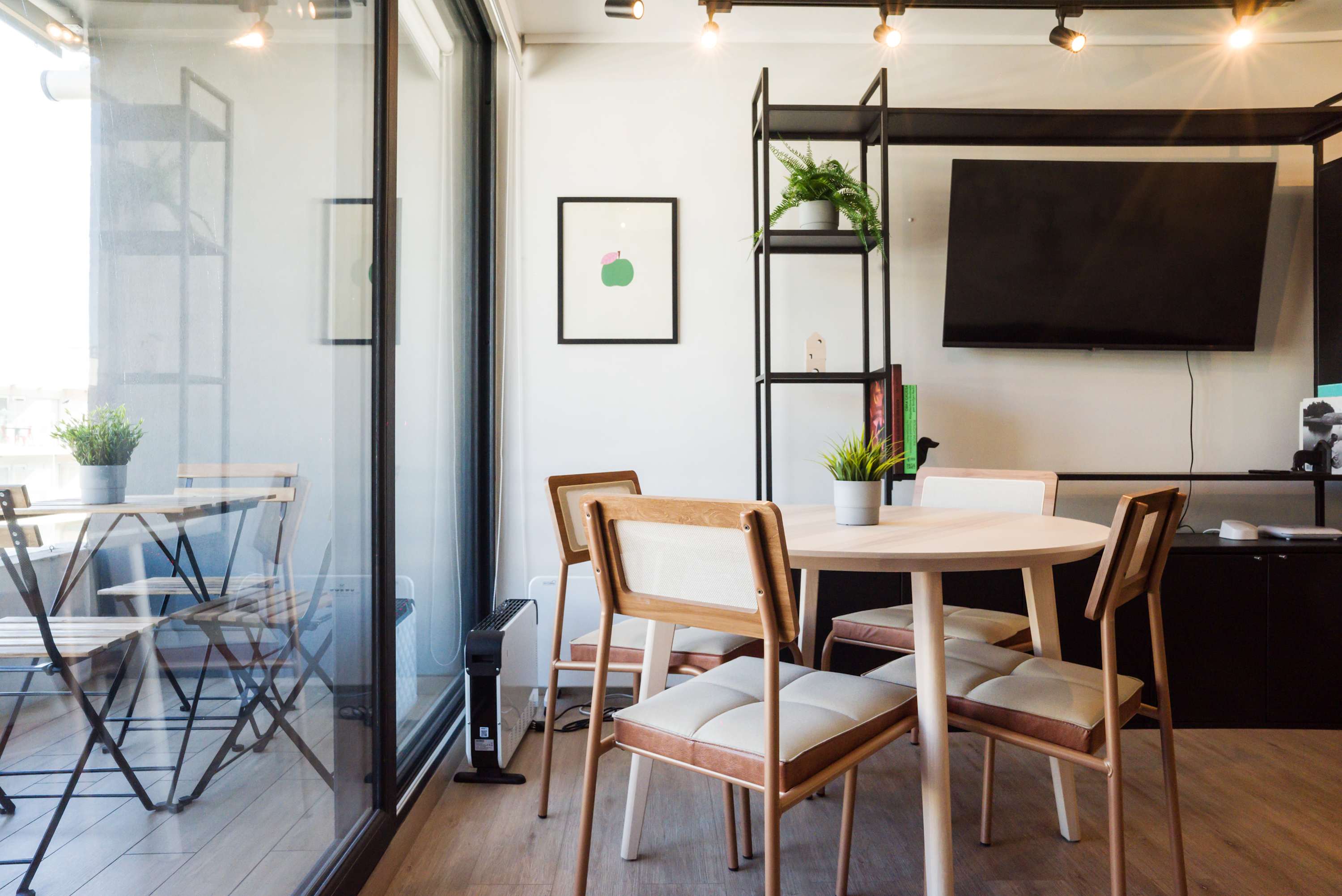 Bright and modern dining area with balcony access, perfect for enjoying meals and relaxation.