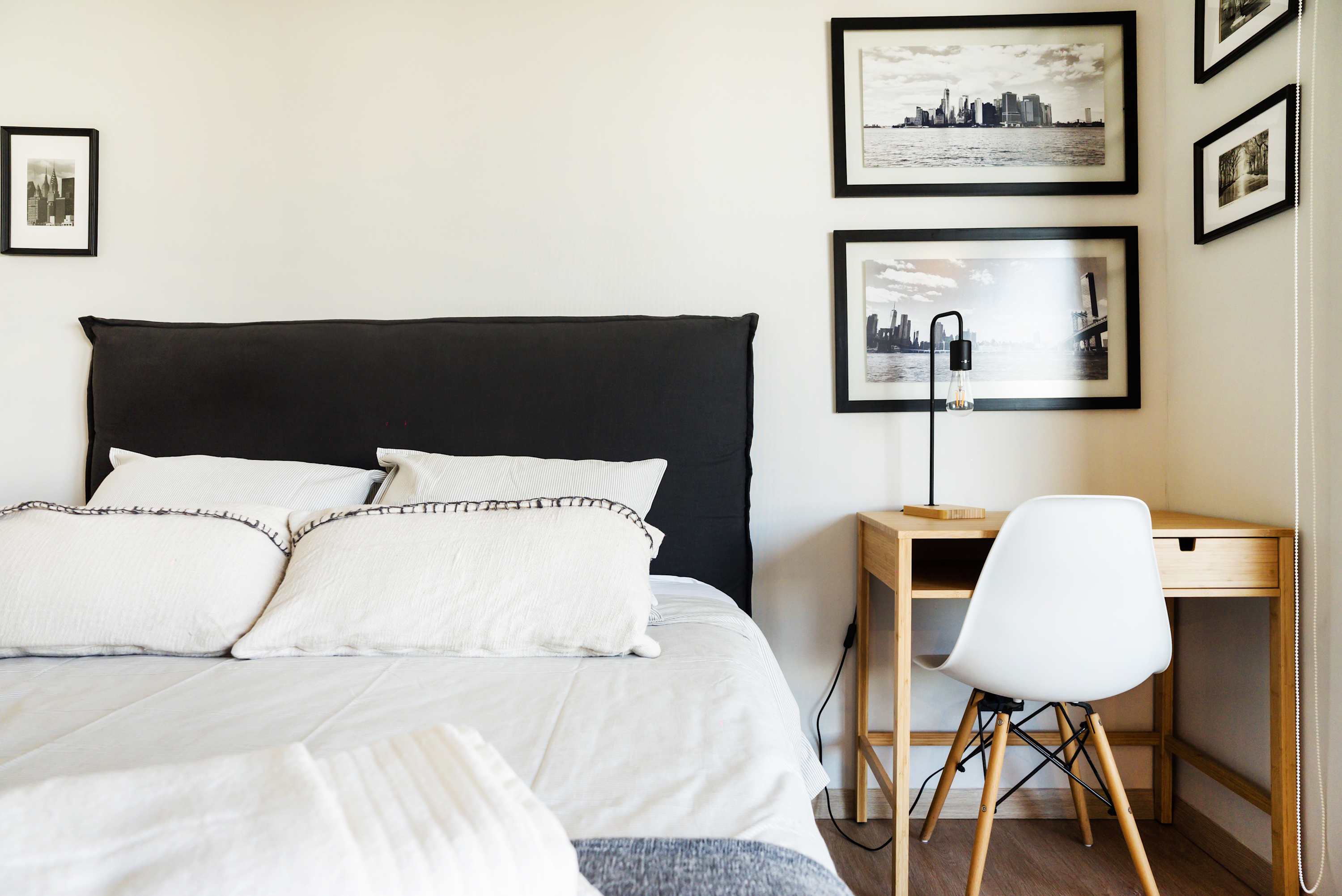 Relax in this stylish bedroom with a comfy bed and workspace, perfect for a cozy retreat.