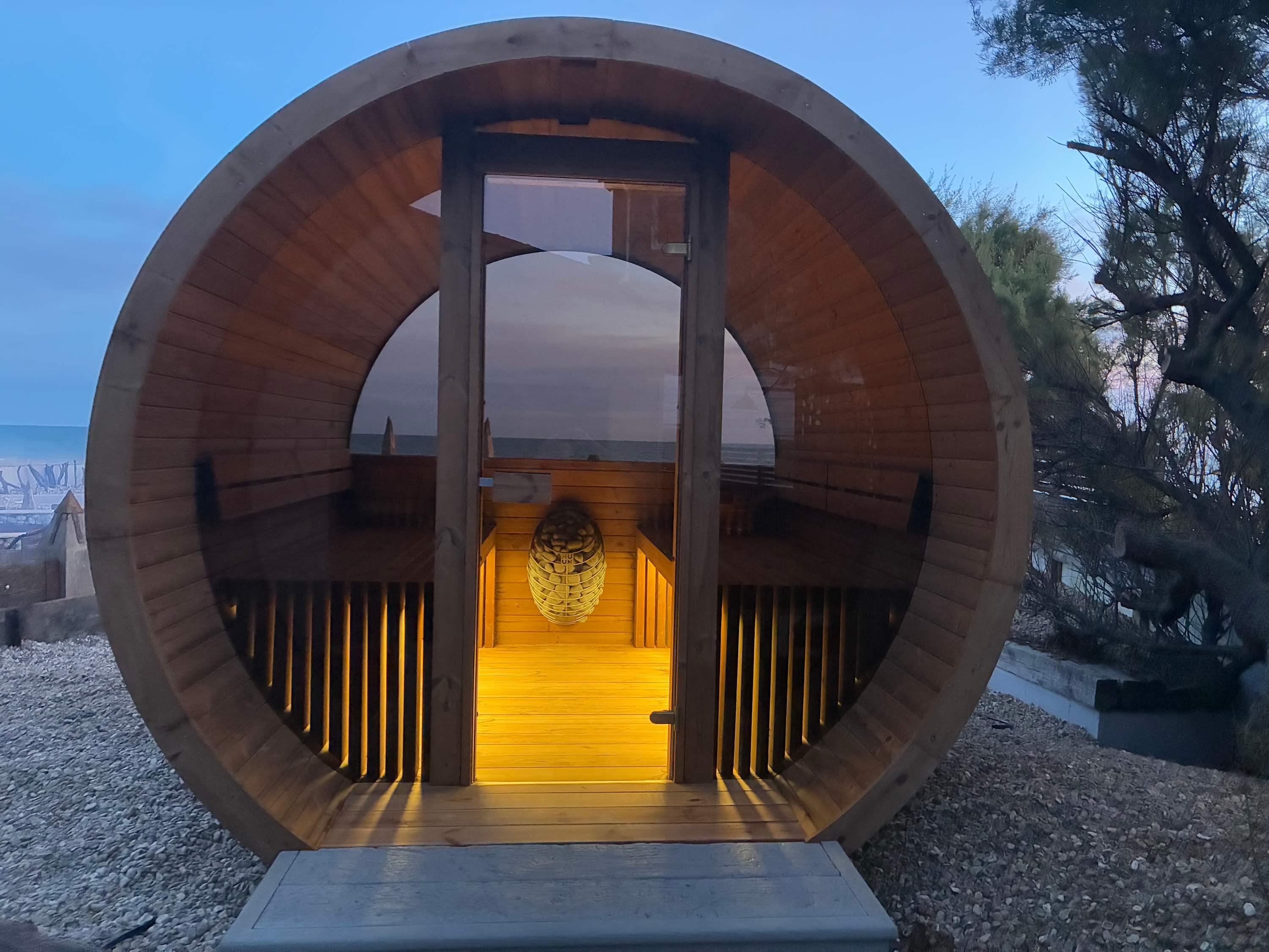 Luxury six-person barrel sauna with breathtaking sea views – your own seaside spa.