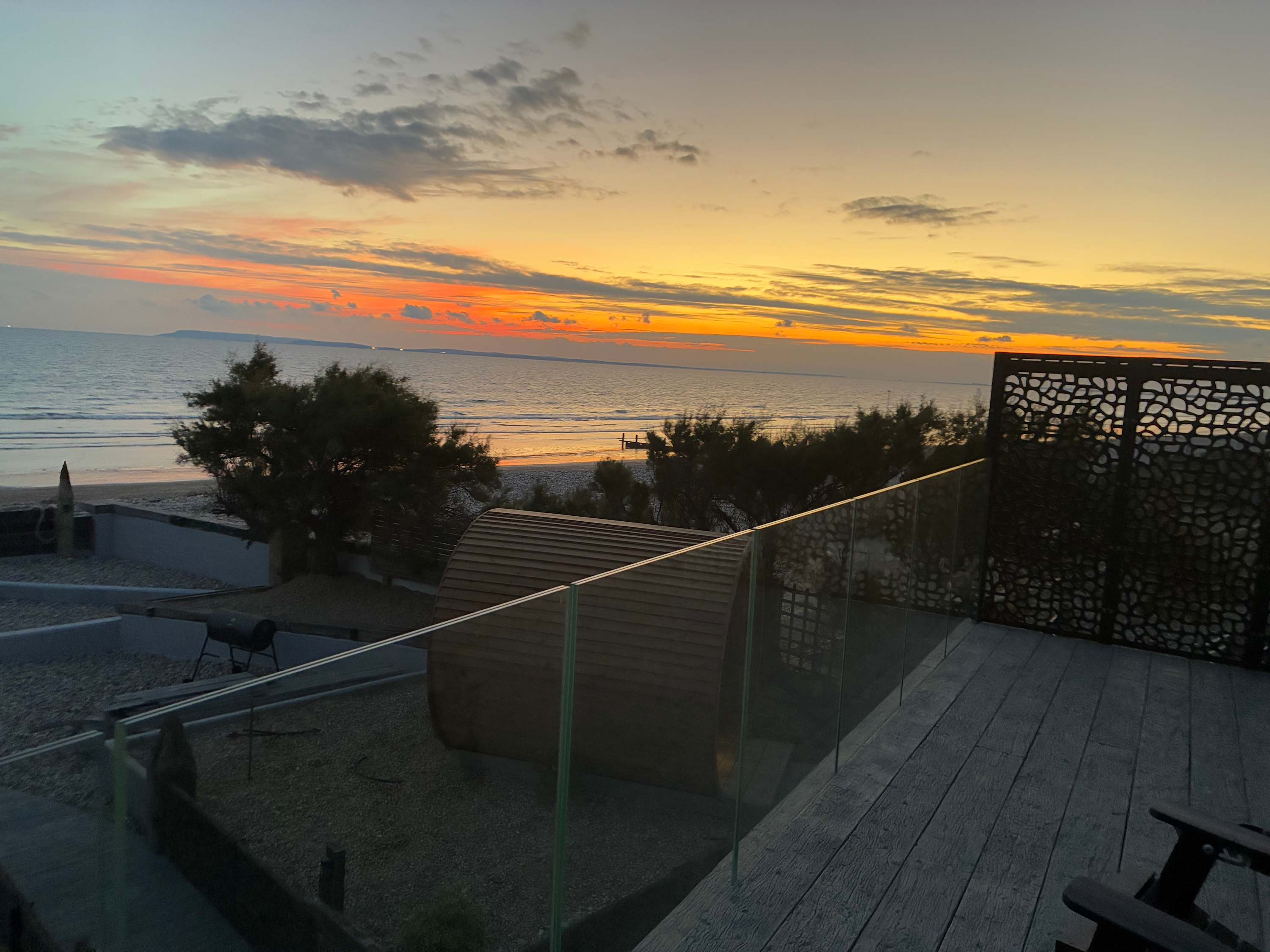 Newly built first-floor balcony with glass balustrade offering panoramic views of the coastline.