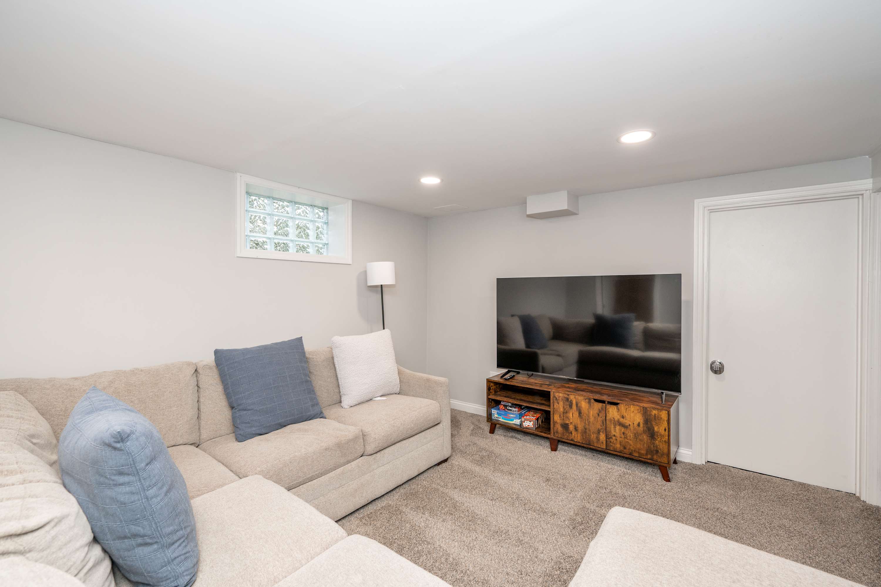 Grab a spot in the lower-level living room & enjoy a movie night at home​