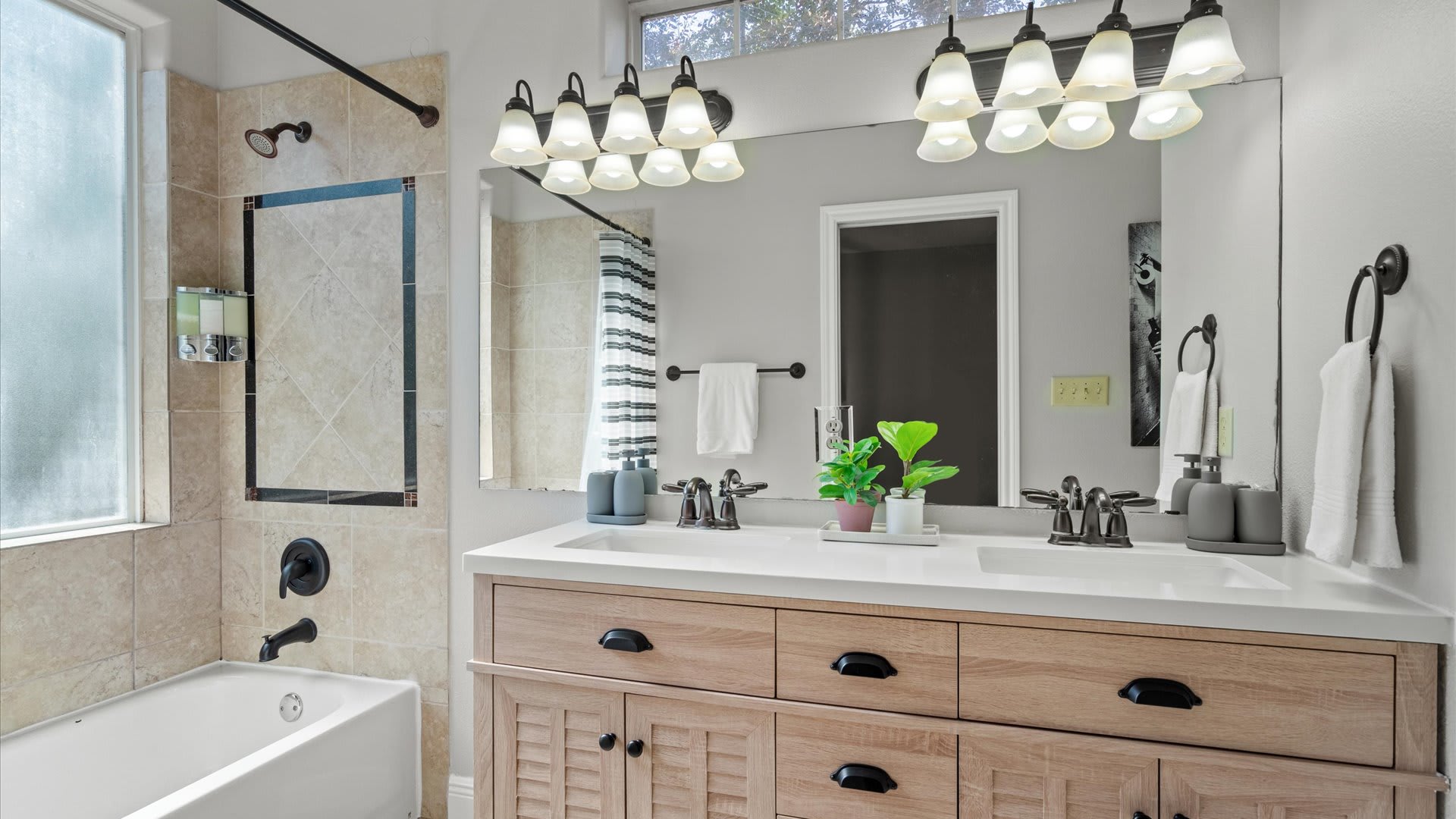 Gorgeous newly renovated en-suite bathroom with double basin and integrated bath and shower 