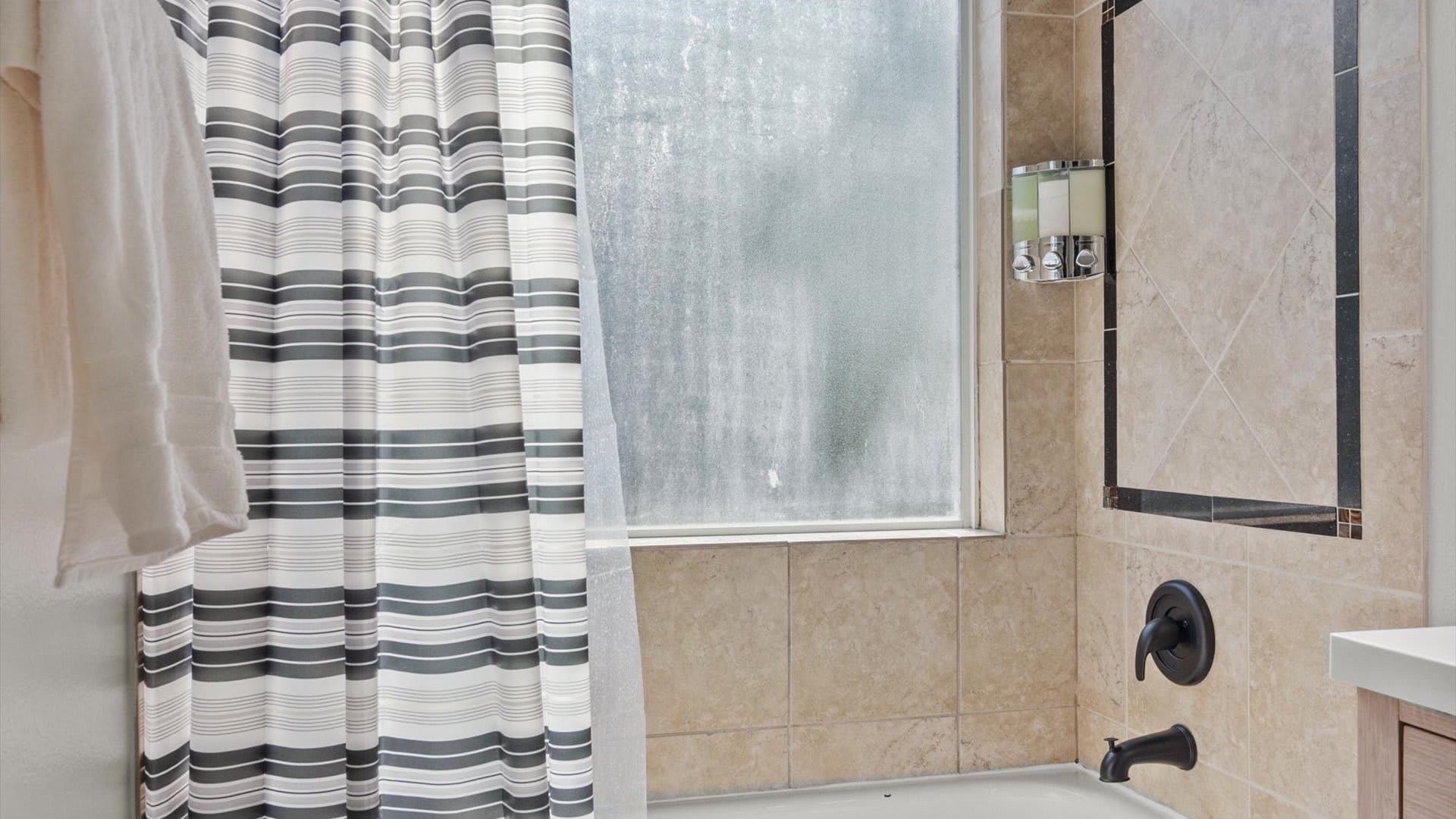 Gorgeous newly renovated en-suite bathroom with integrated bath and shower 