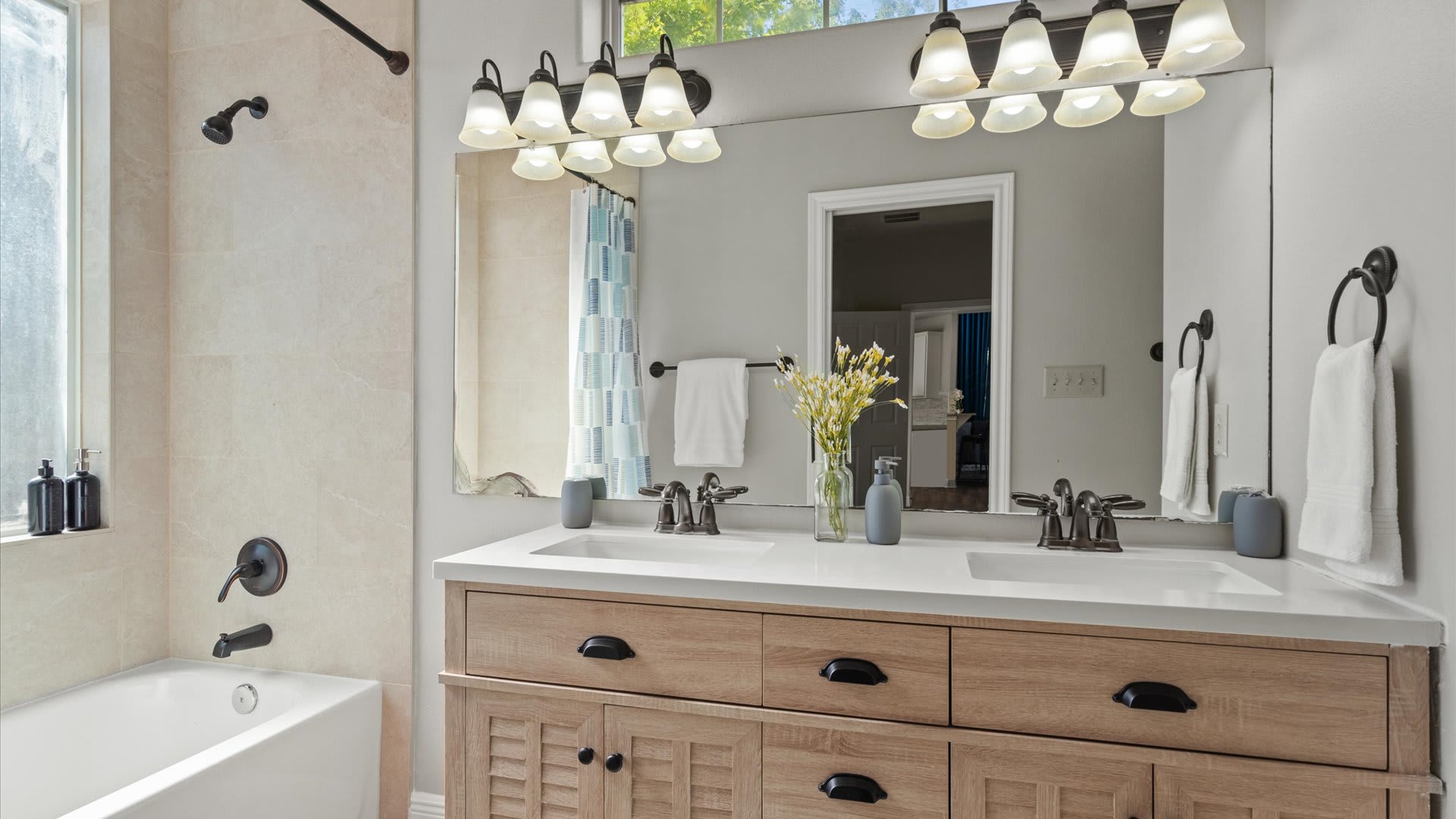 Modern en-suite bathroom with double basin and integrated bathtub and shower