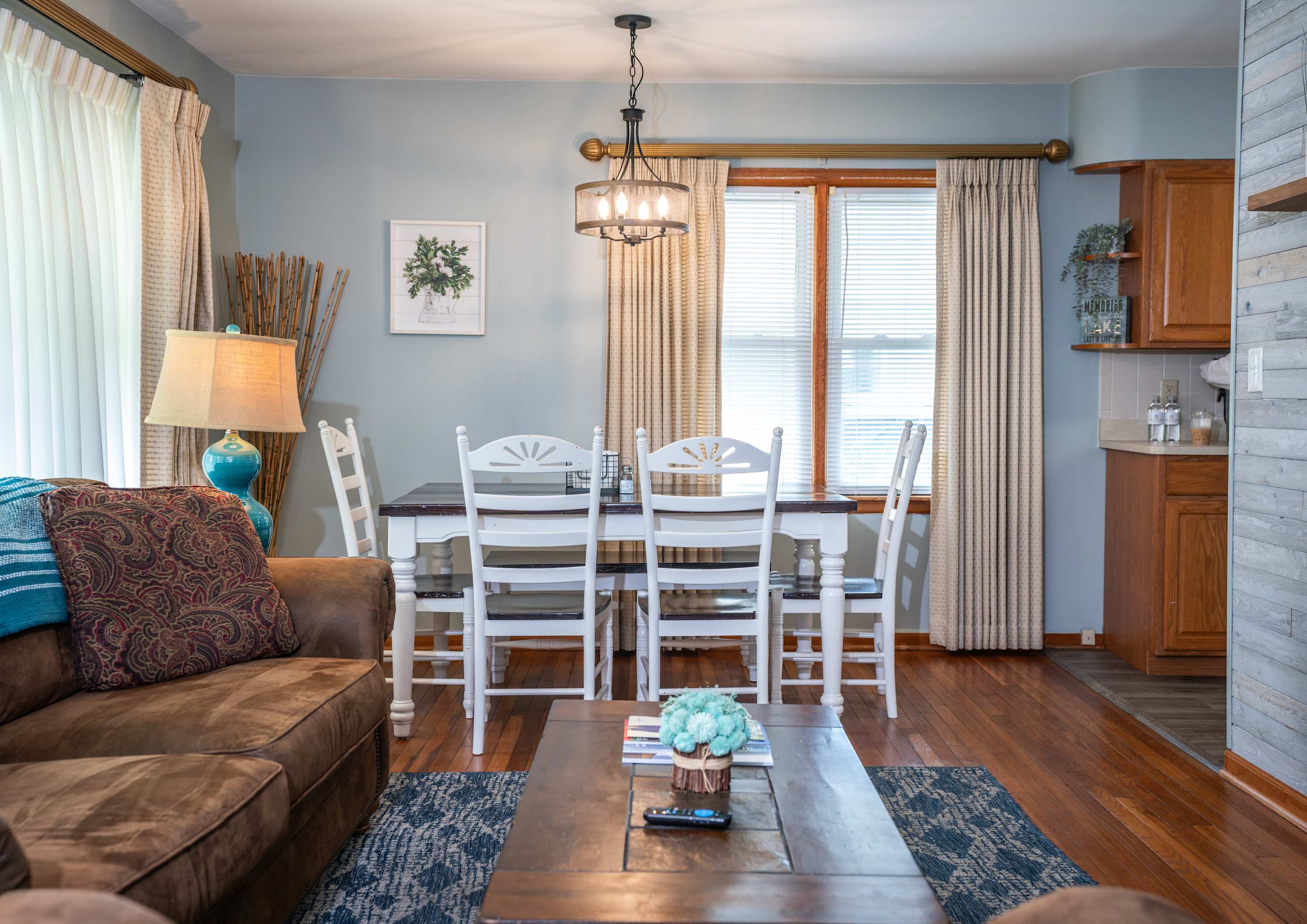 Dining room area seats four with natural lighting.