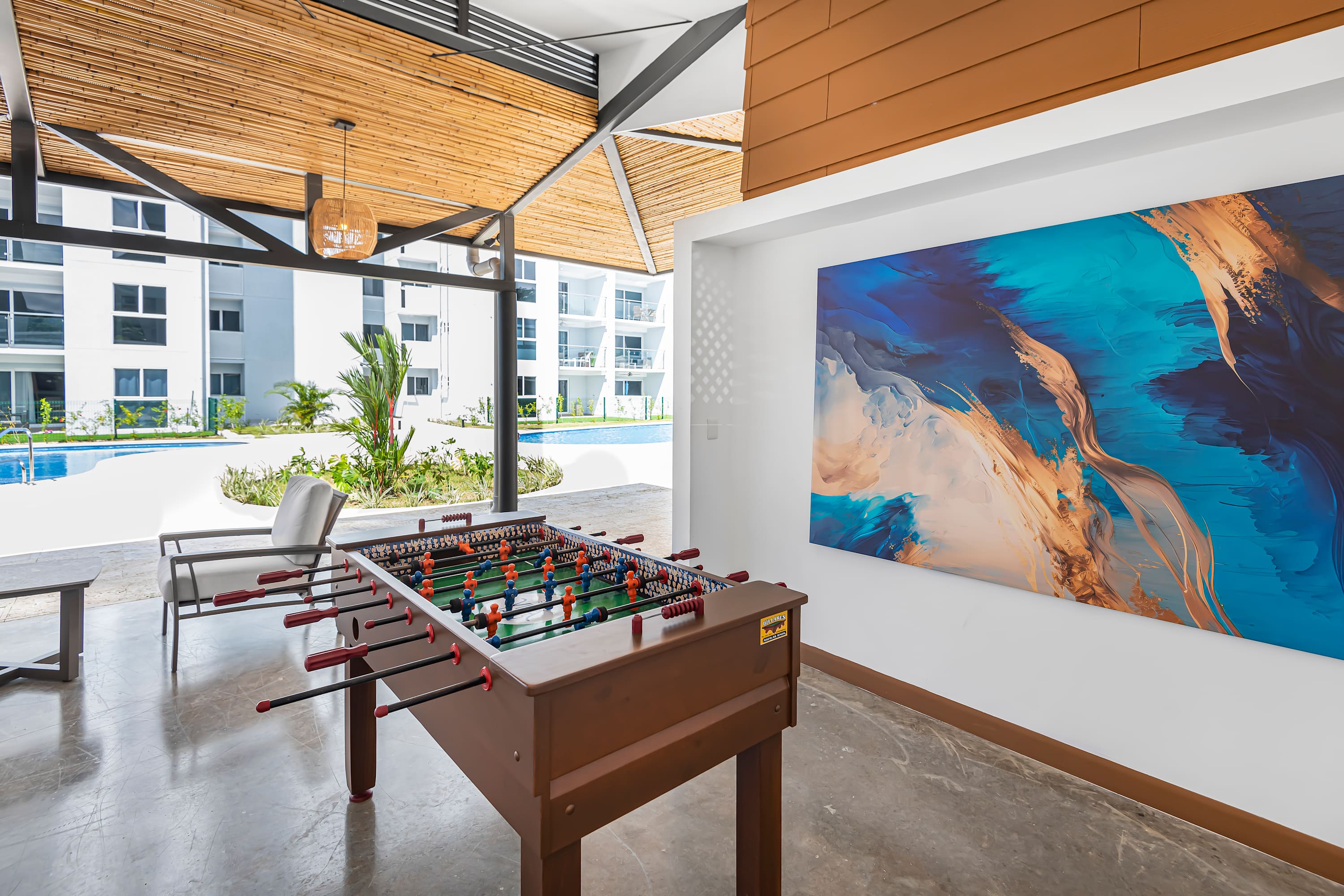 Communal Lounge Area: Open Concept with Pool Table & Seating - A vibrant open-concept lounge designed for connection and fun. Featuring ample seating and a pool and a foosball table. 