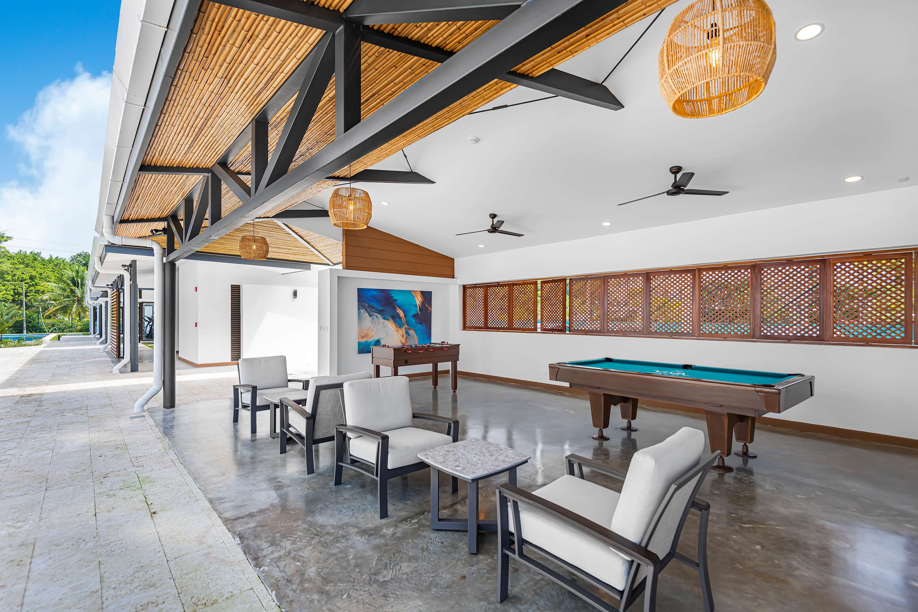 Communal Lounge Area: Open Concept with Pool Table & Seating - A vibrant open-concept lounge designed for connection and fun. Featuring ample seating and a pool and a foosball table. 