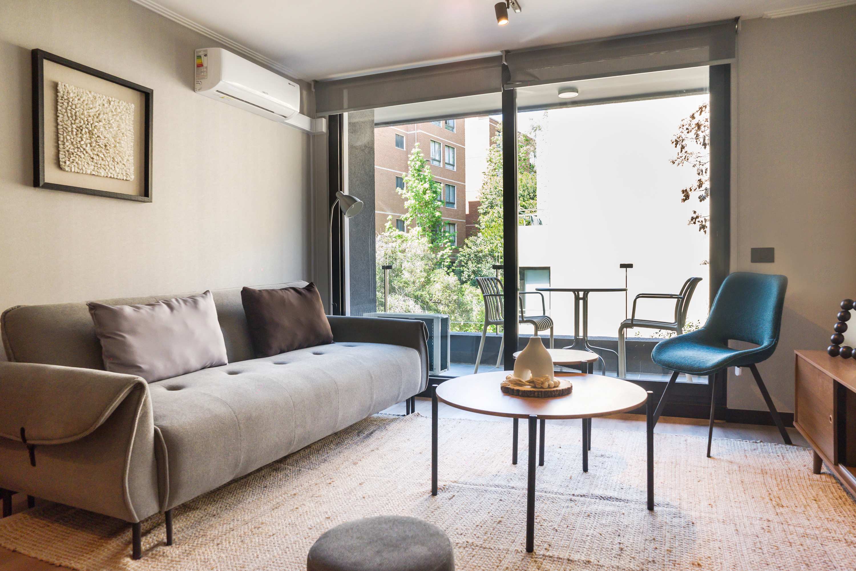 Modern living room with balcony access and cozy seating, perfect for relaxation and enjoying the view.