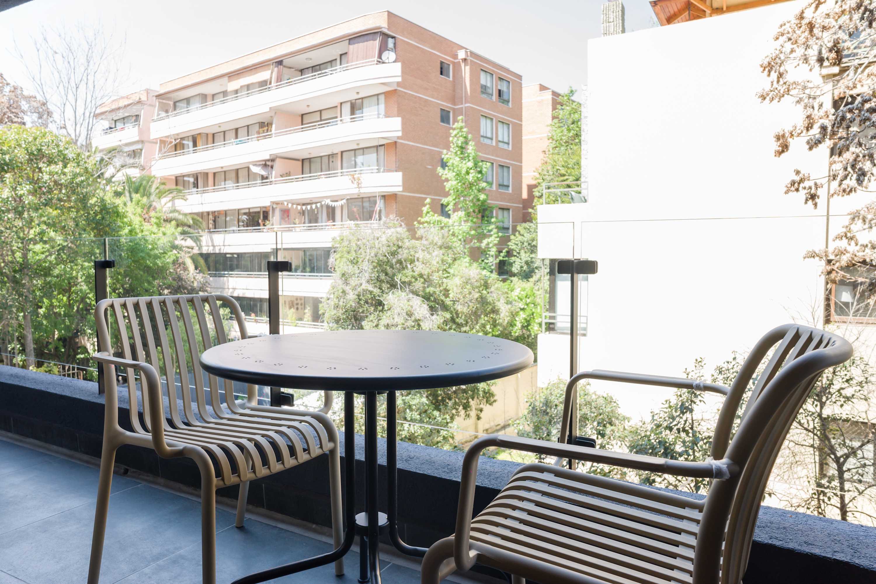 Relax on your private balcony with stunning views of lush greenery and the cityscape.