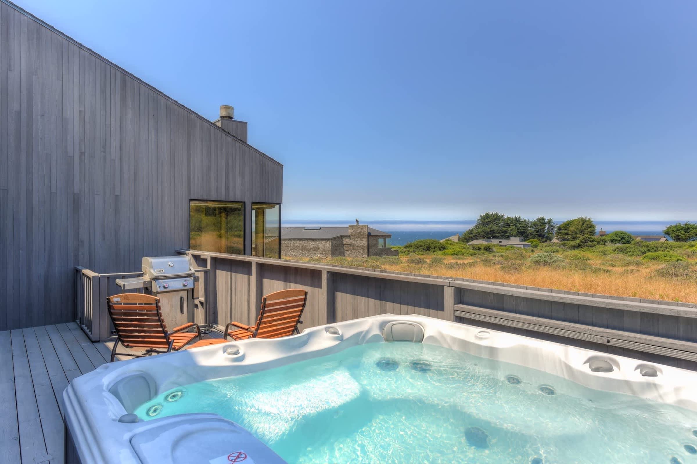Ocean-view patio with a bubbly hot tub and a BBQ grill.