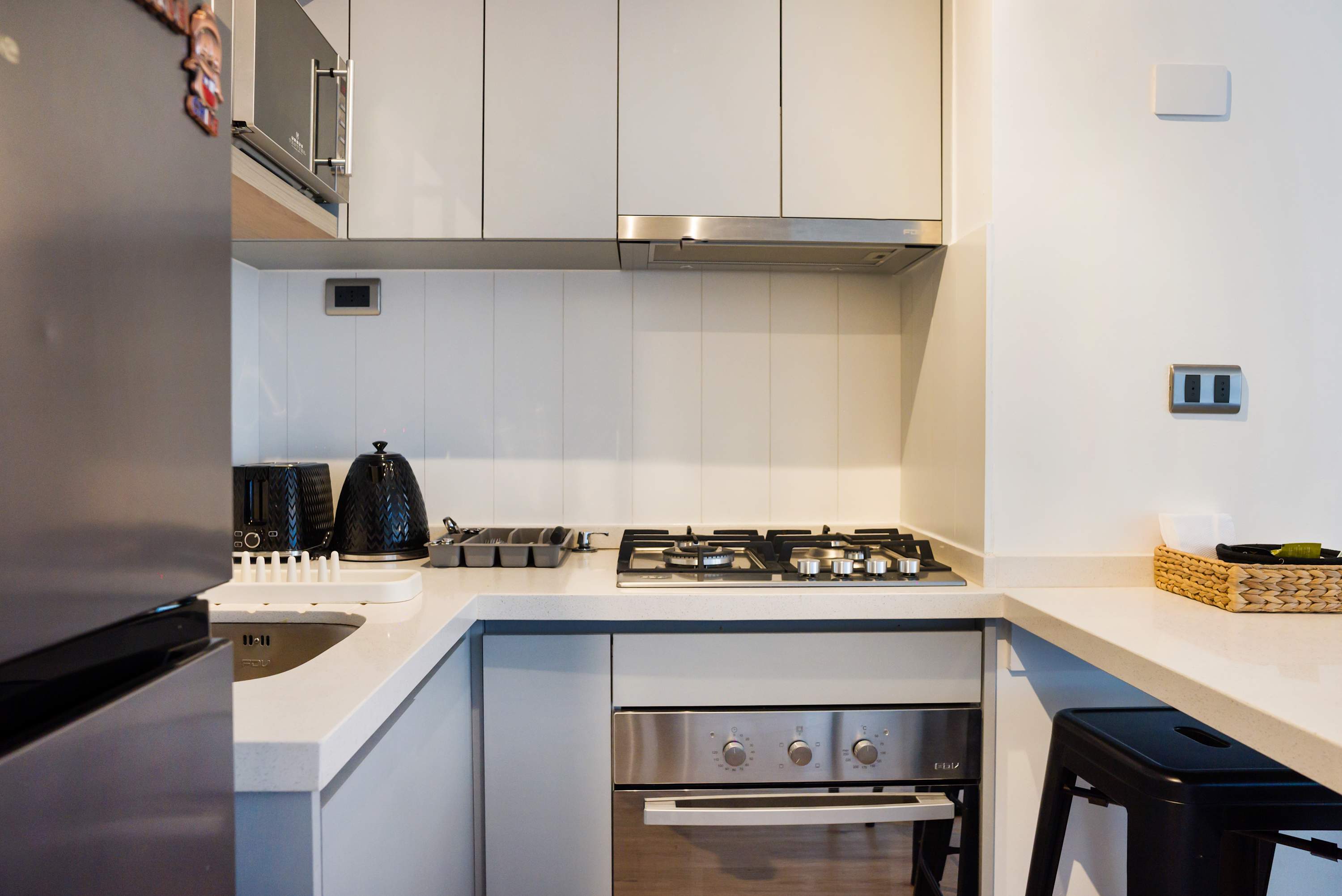 Modern kitchen with sleek appliances and ample counter space, perfect for culinary adventures.