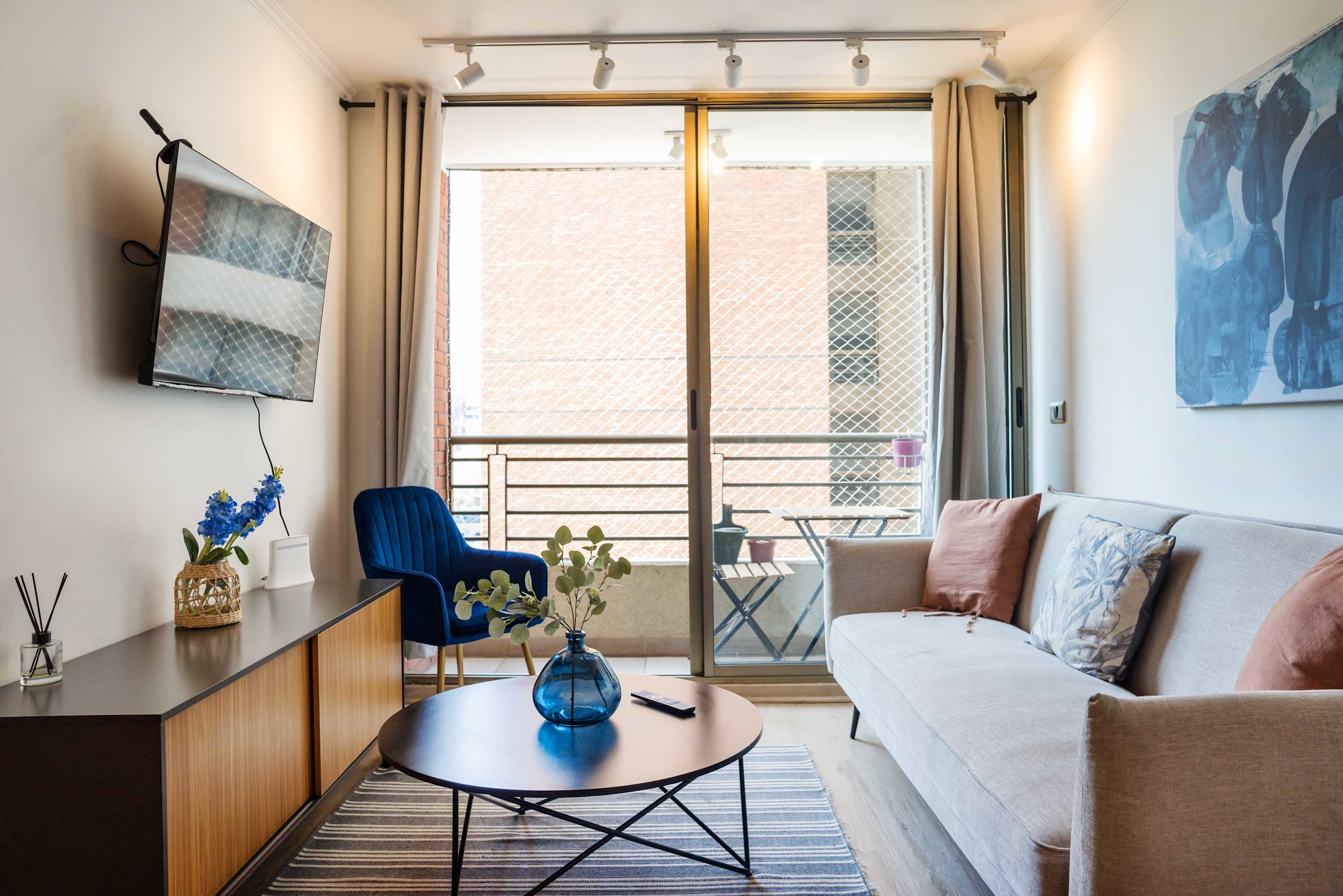 Bright and stylish living room with a balcony view, perfect for unwinding after a day of exploring.