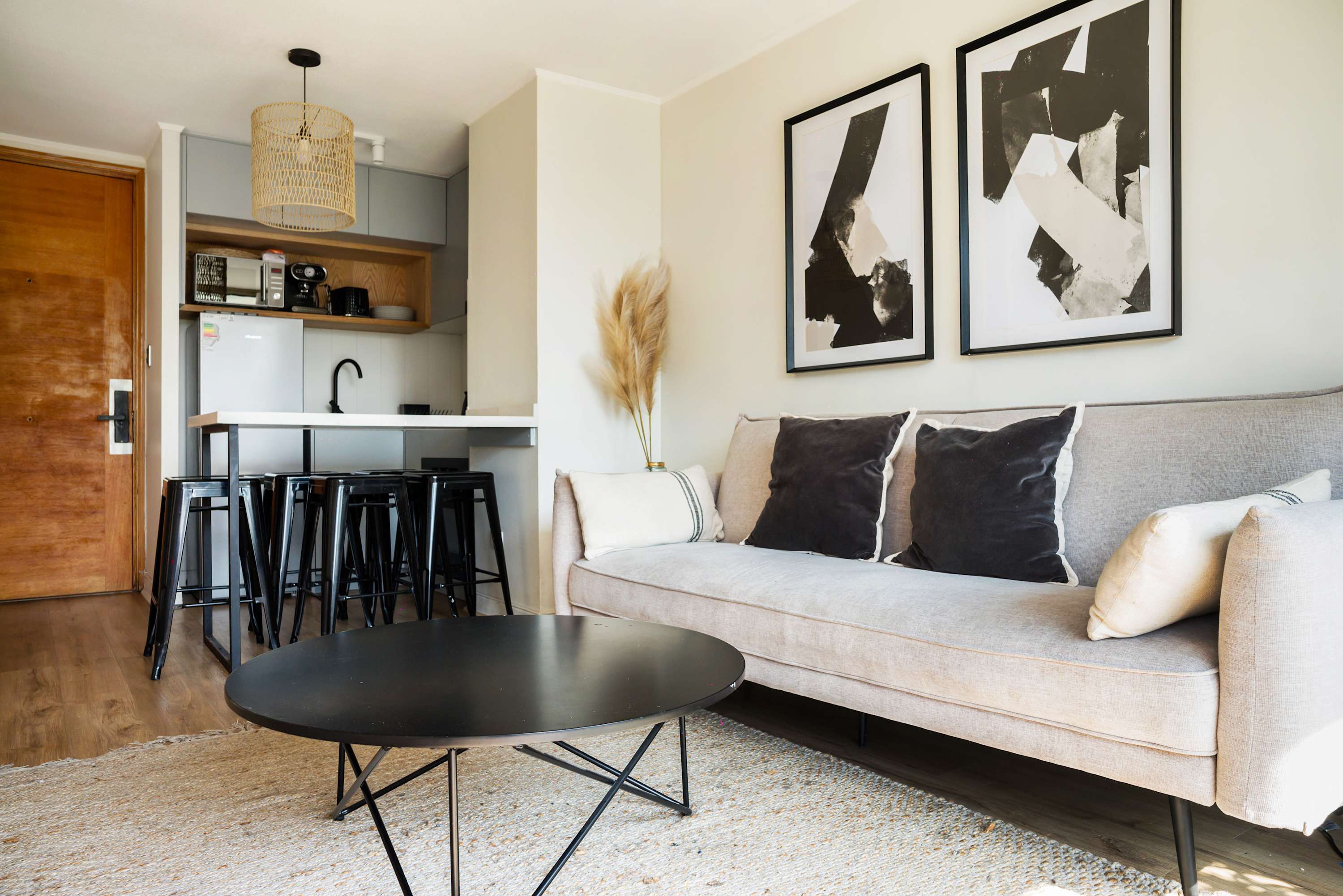 Chic and cozy living area with modern decor and a convenient kitchen space, ideal for relaxation and socializing.