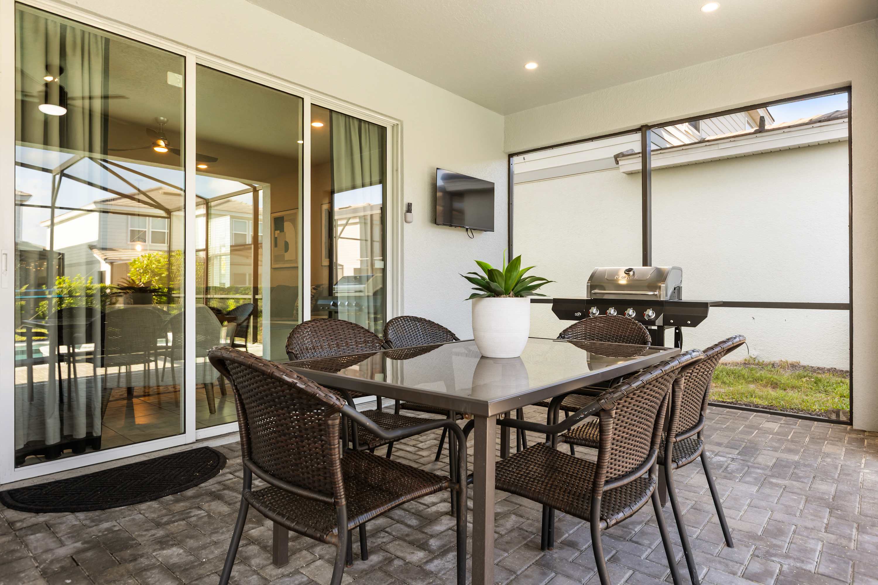 Patio - Covered patio with a BBQ Grill and comfortable seating that overlooks the pool—perfect for morning coffee, evening drinks, or watching the kids swim.