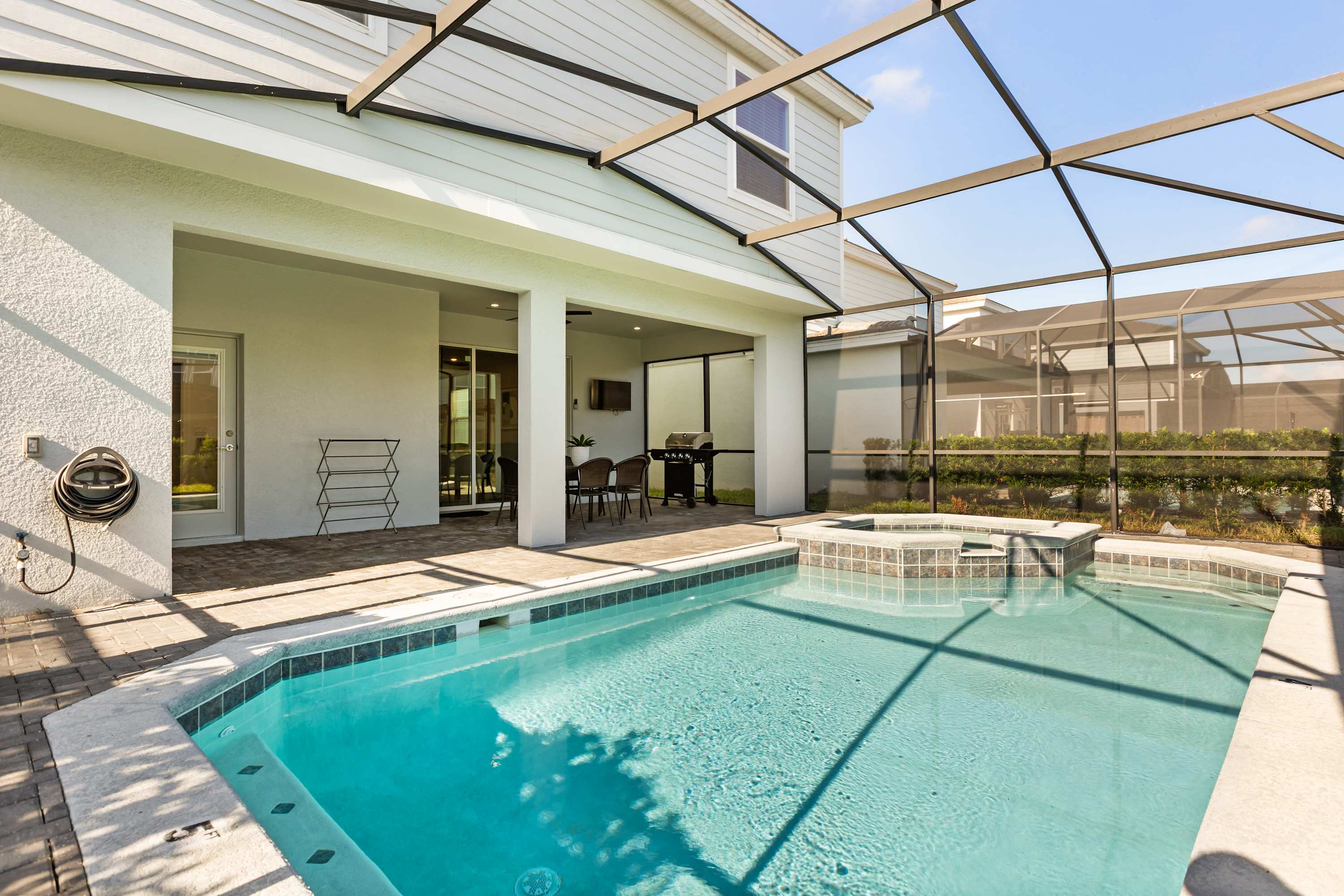 Outdoor Pool - Soak up the sun by your private screened-in pool, complete with lounge chairs and plenty of space for family fun or quiet relaxation.