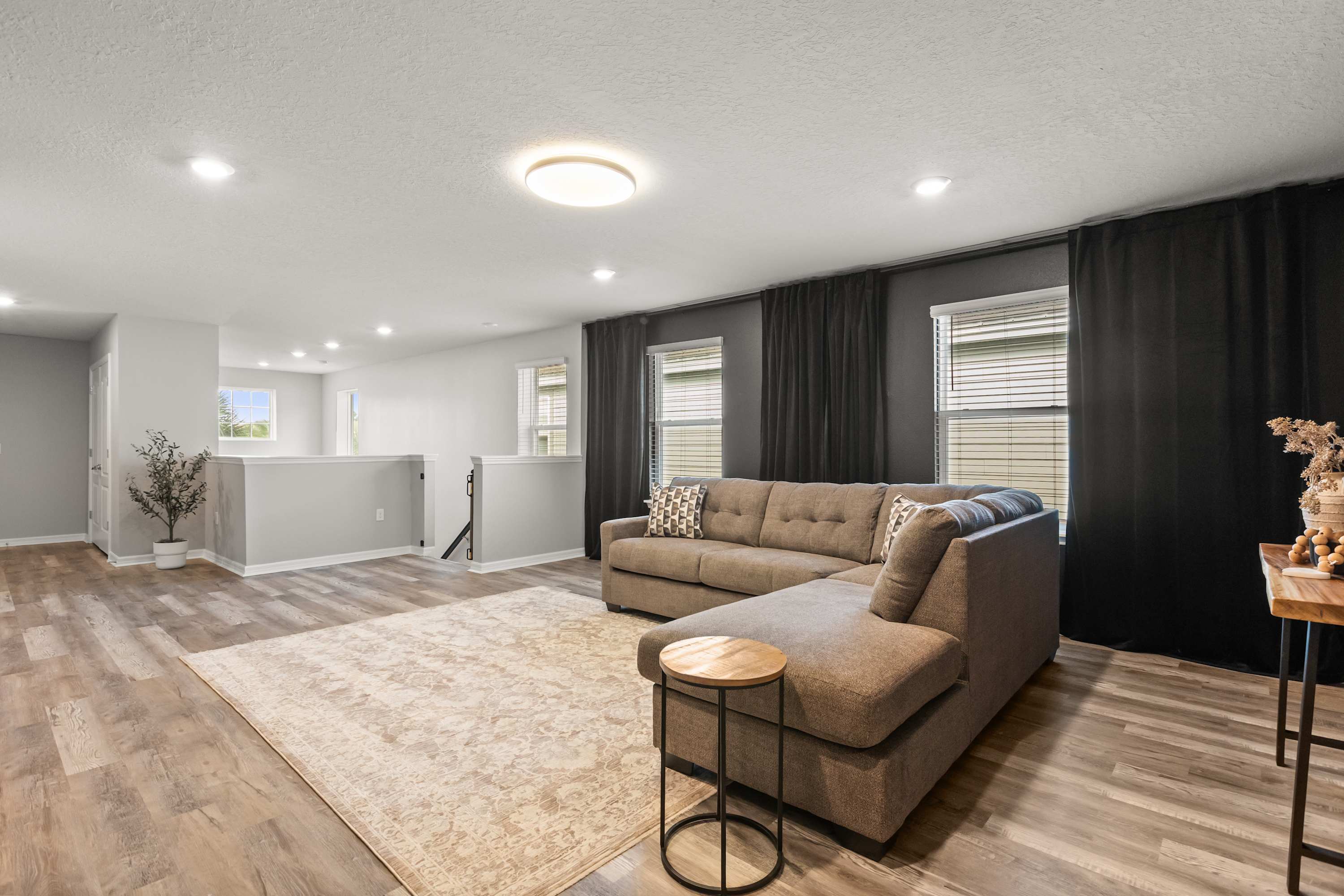 Upstairs TV Lounge / Loft - Cozy upstairs lounge with a big-screen TV and queen sleeper sofa—great for movies, games, or extra sleeping space.
