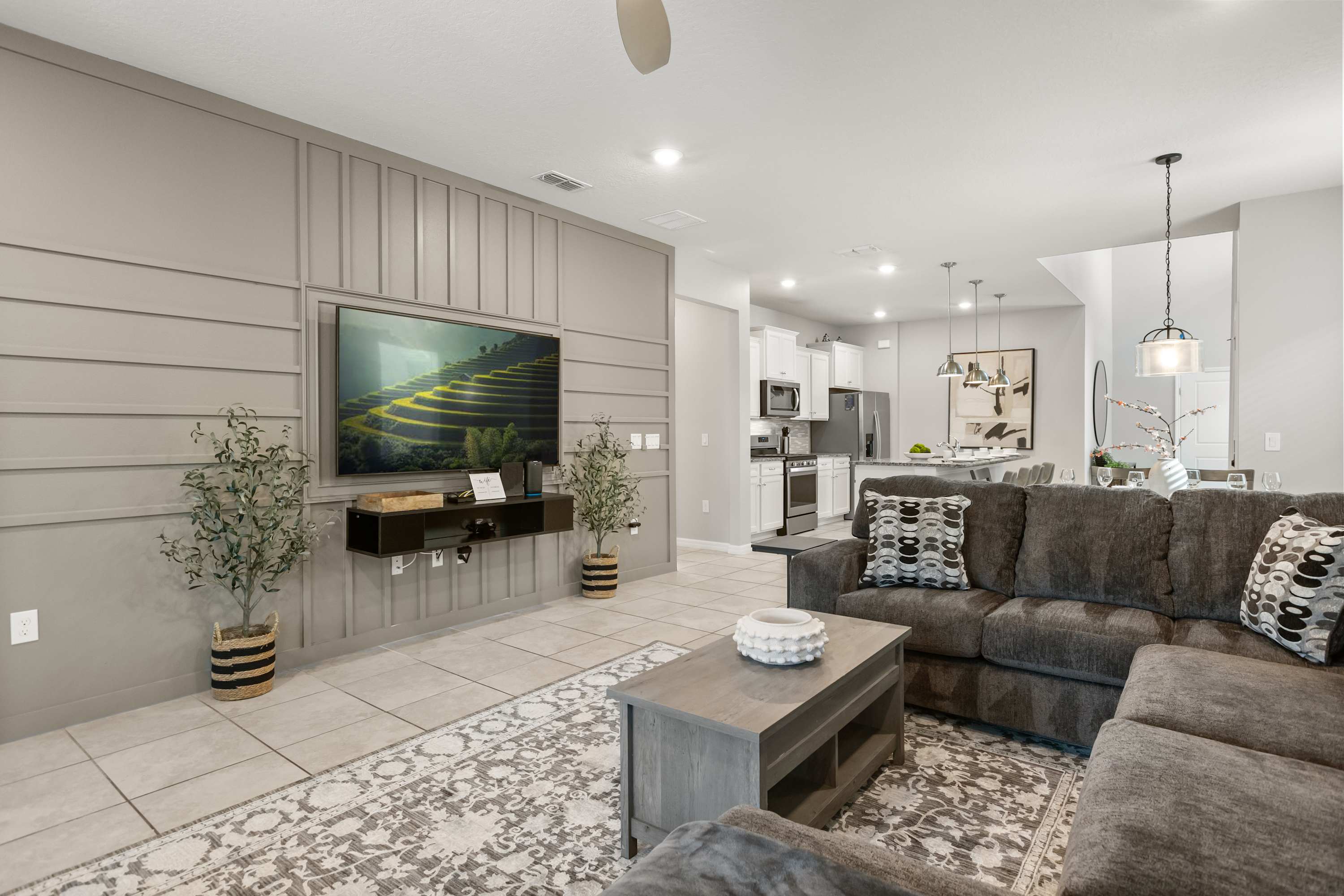 Downstairs TV Lounge - Comfortable main-floor TV lounge with cozy seating and a large screen—perfect for movie nights, sports, or relaxing after a day out.