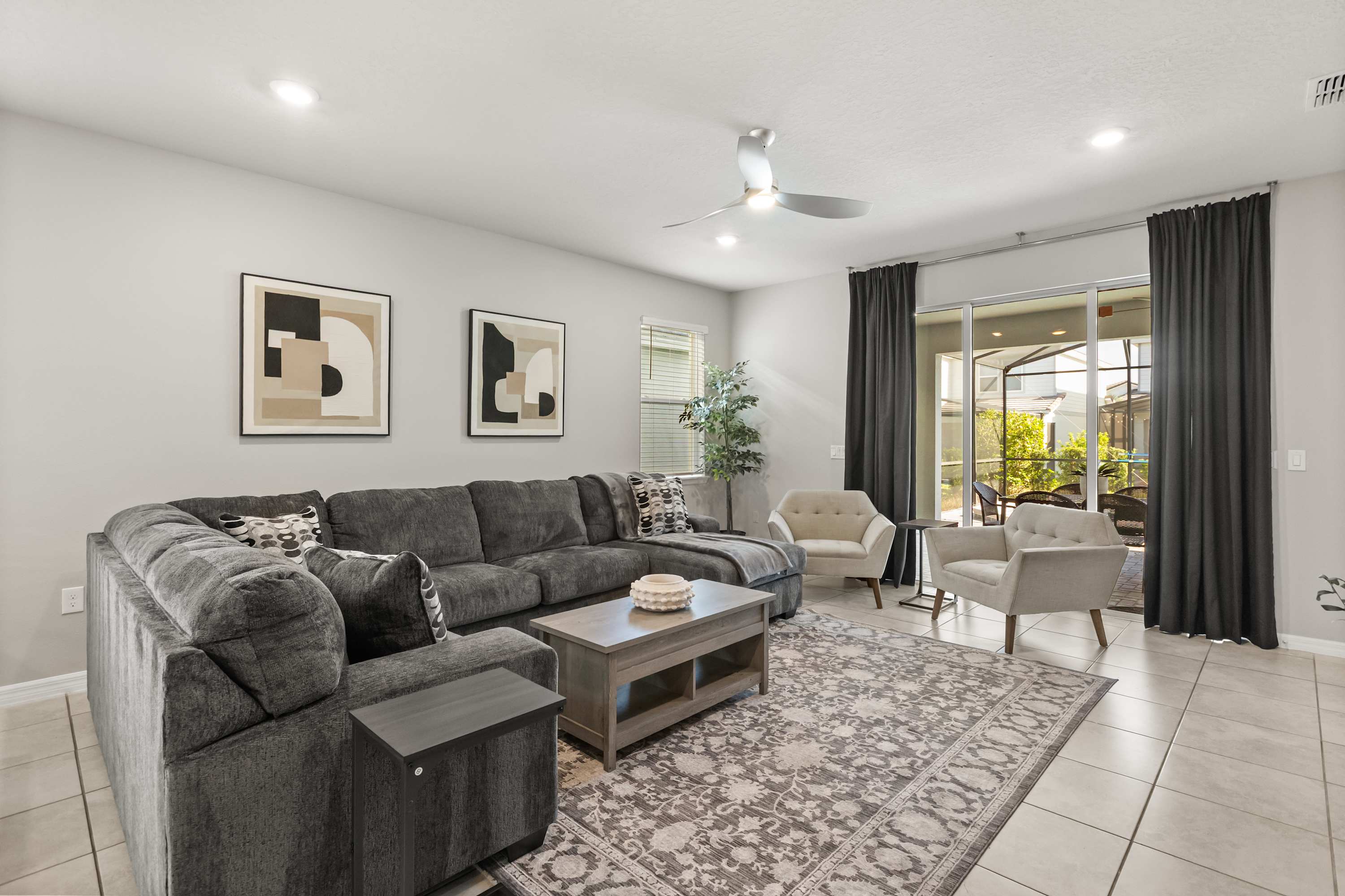 Downstairs TV Lounge - Comfortable main-floor TV lounge with cozy seating and a large screen—perfect for movie nights, sports, or relaxing after a day out.