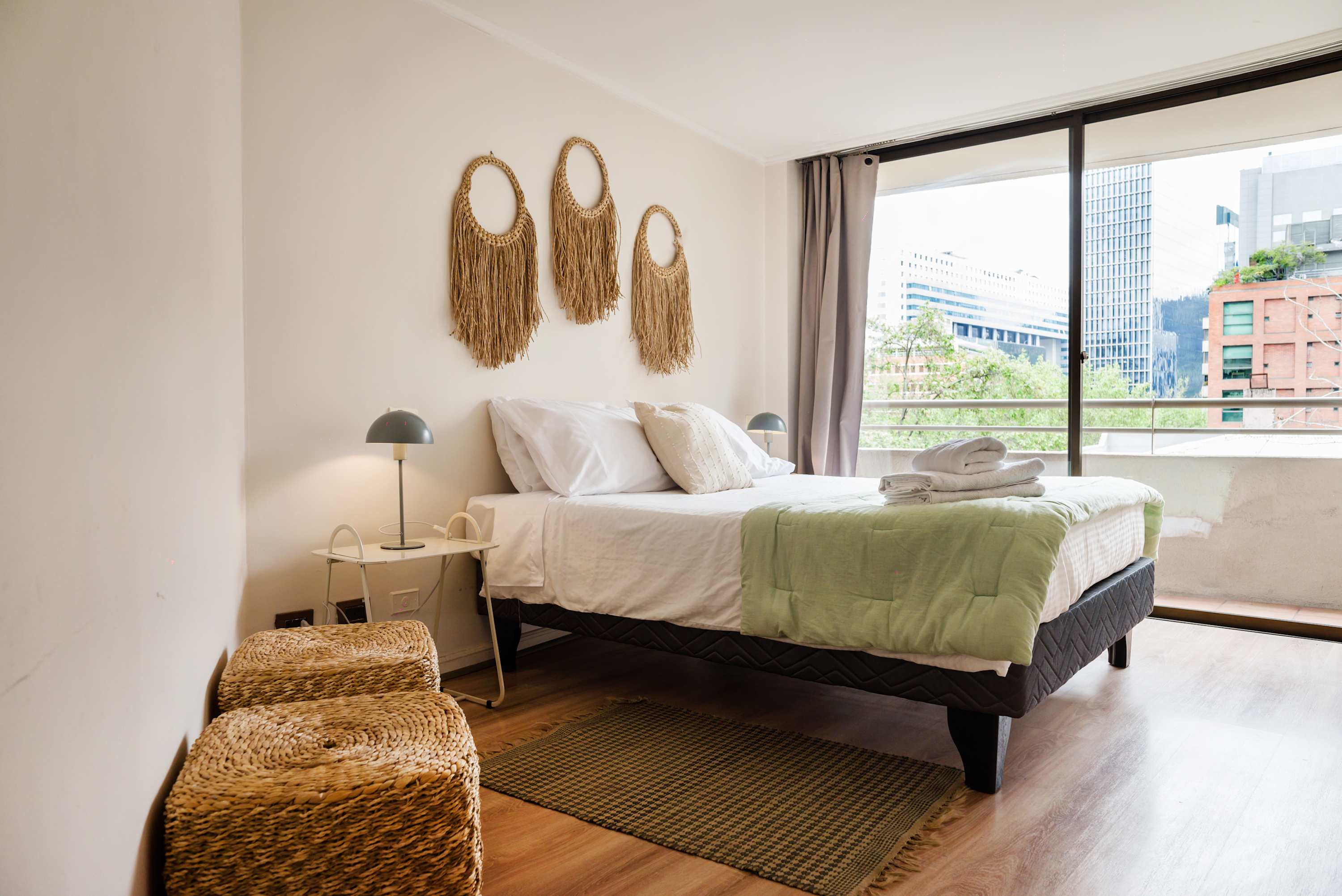 Cozy bedroom with city views, natural light, and stylish decor perfect for a relaxing stay in the heart of the city.