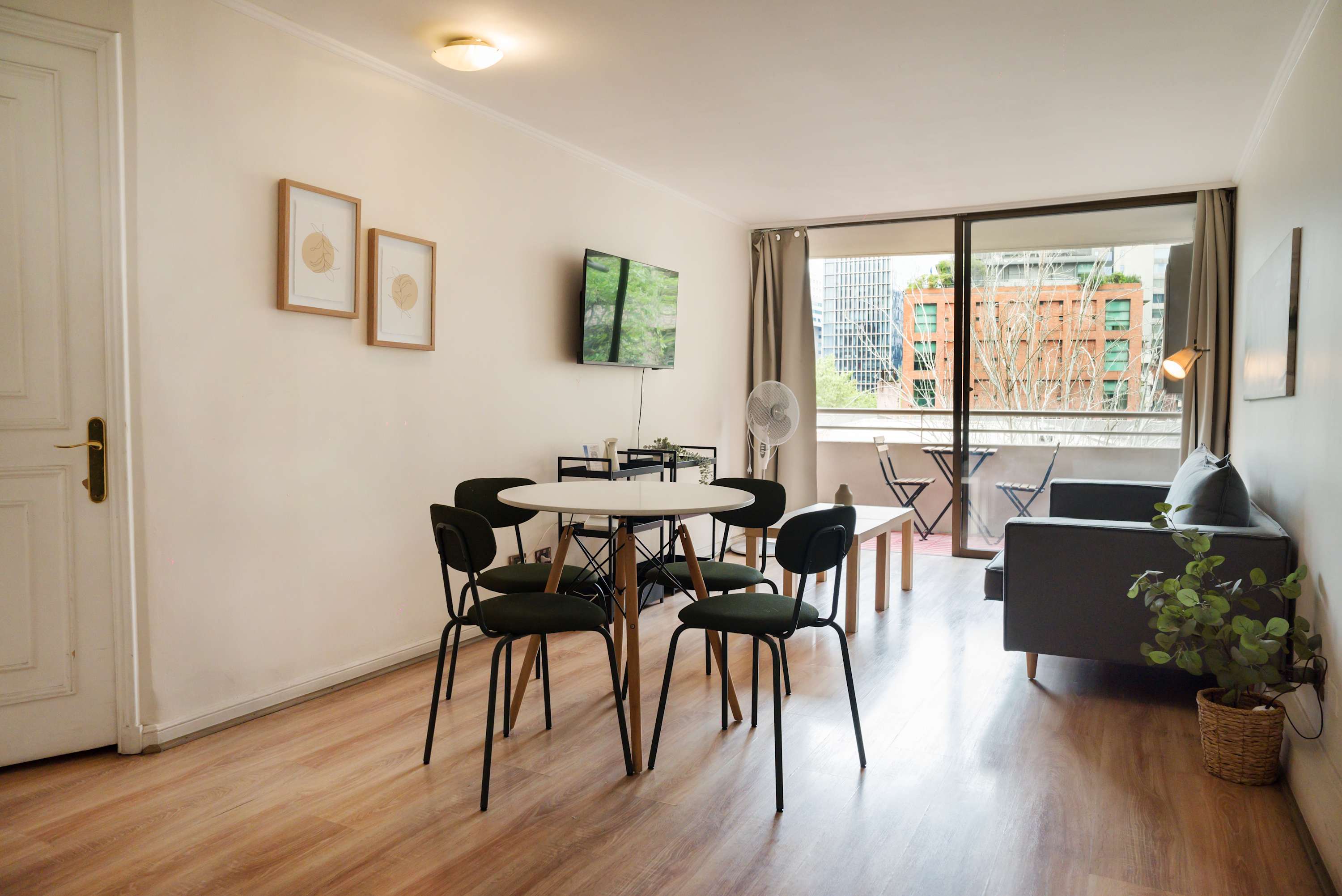 Bright and airy living space with city views, perfect for relaxation and dining.