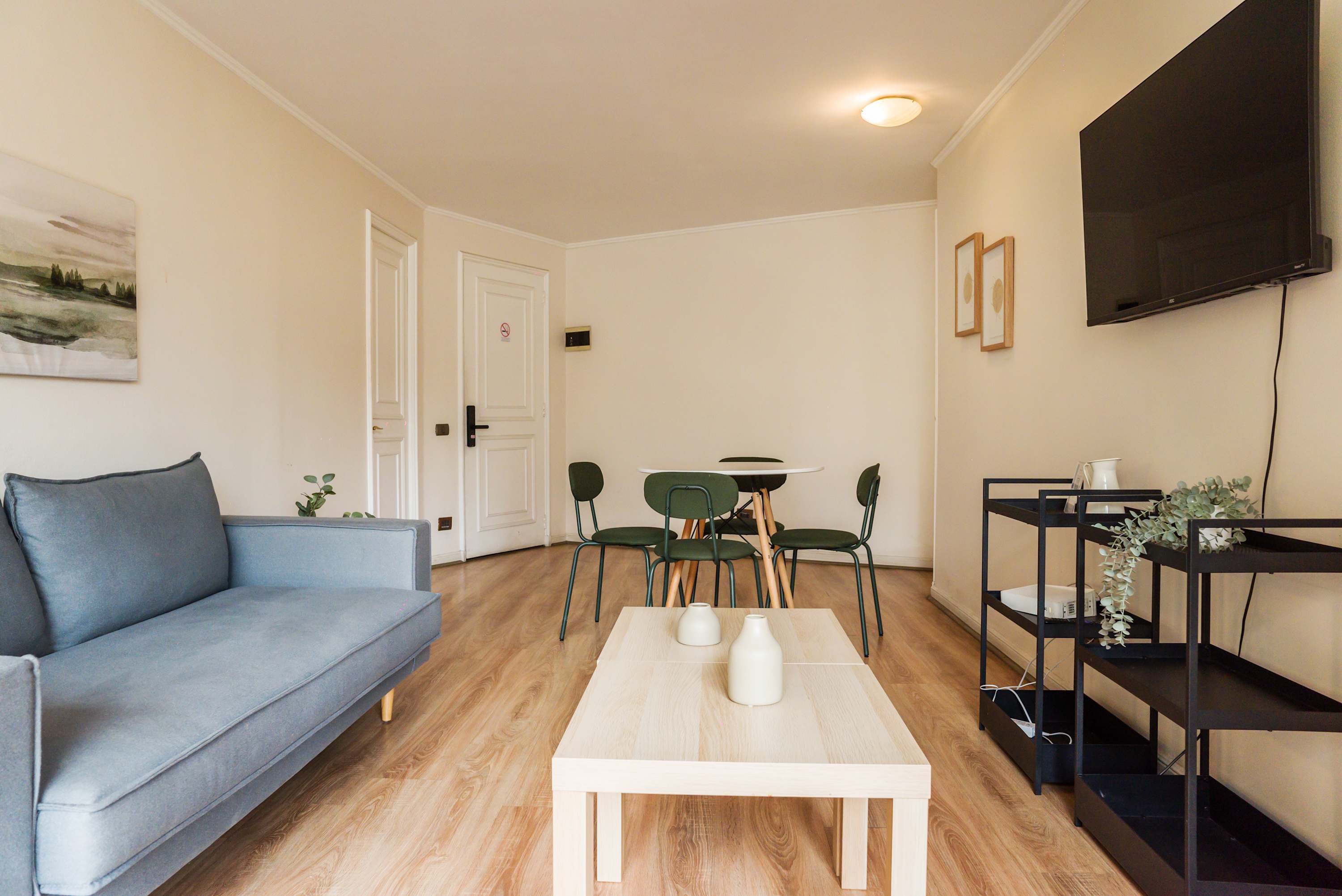 Cozy living area with modern decor and a wall-mounted TV, perfect for relaxing after a day of exploring.