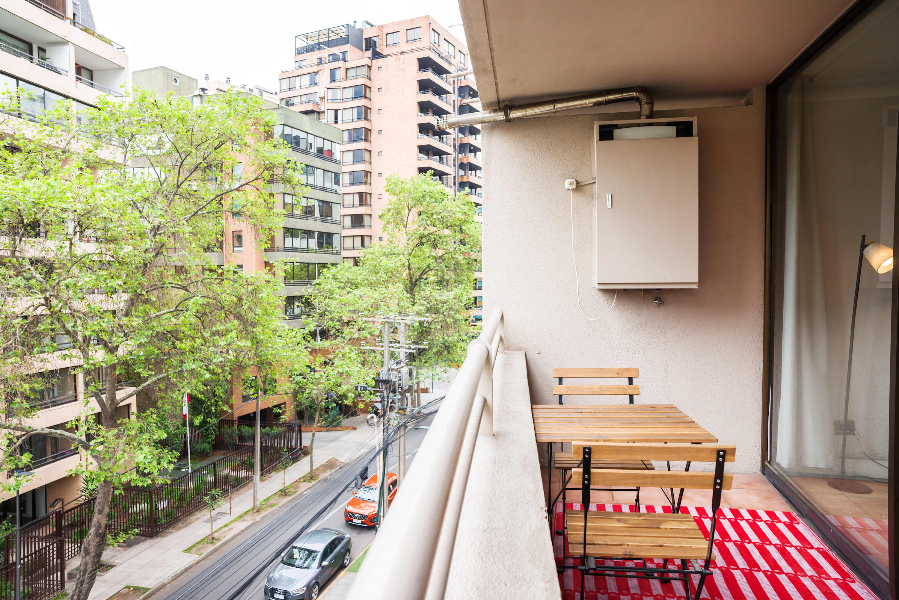 Enjoy your morning coffee on this cozy balcony with city views, perfect for relaxation.