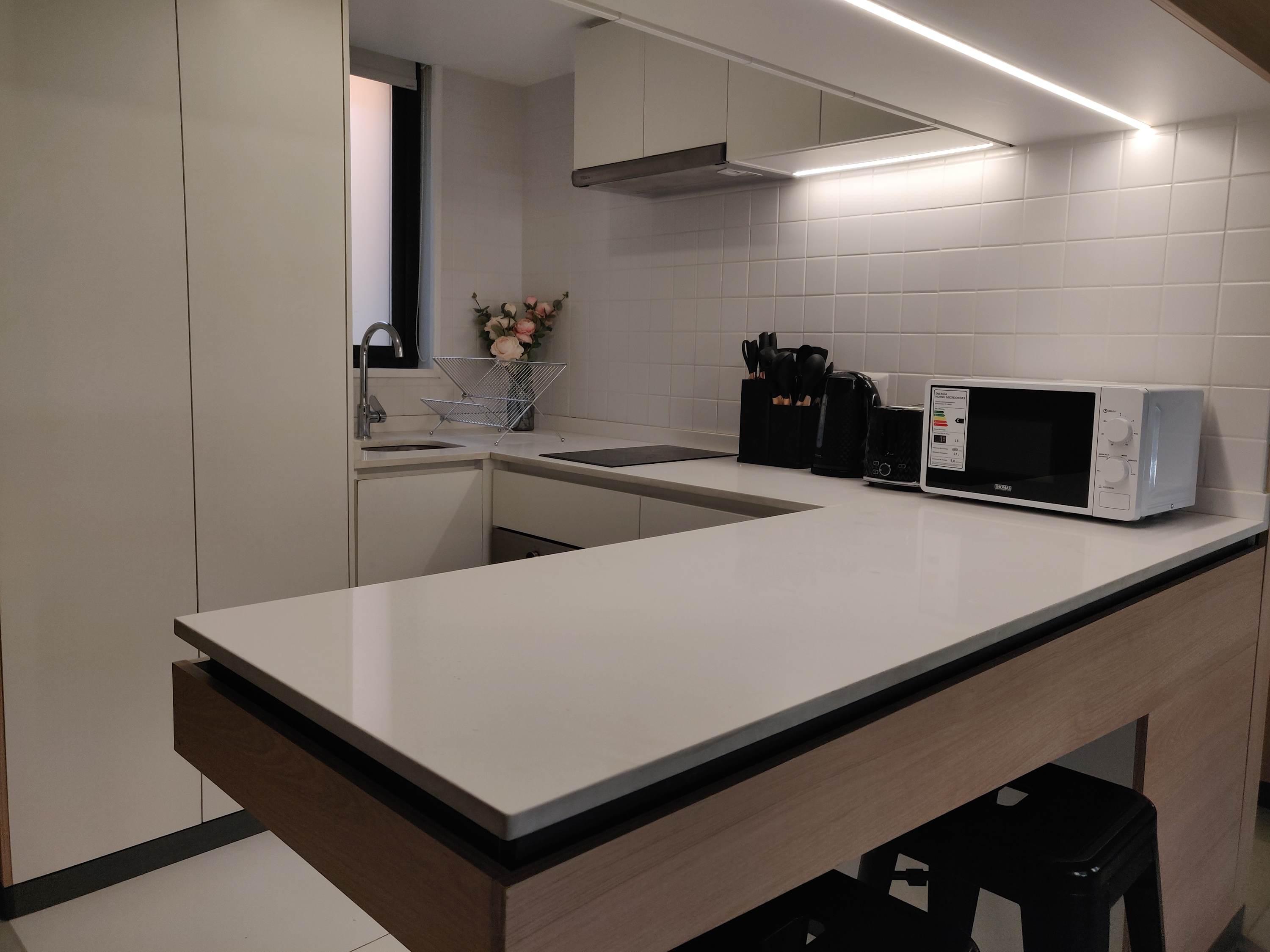 Sleek and modern kitchen with all essentials for a comfortable stay. Perfect for cooking your favorite meals.