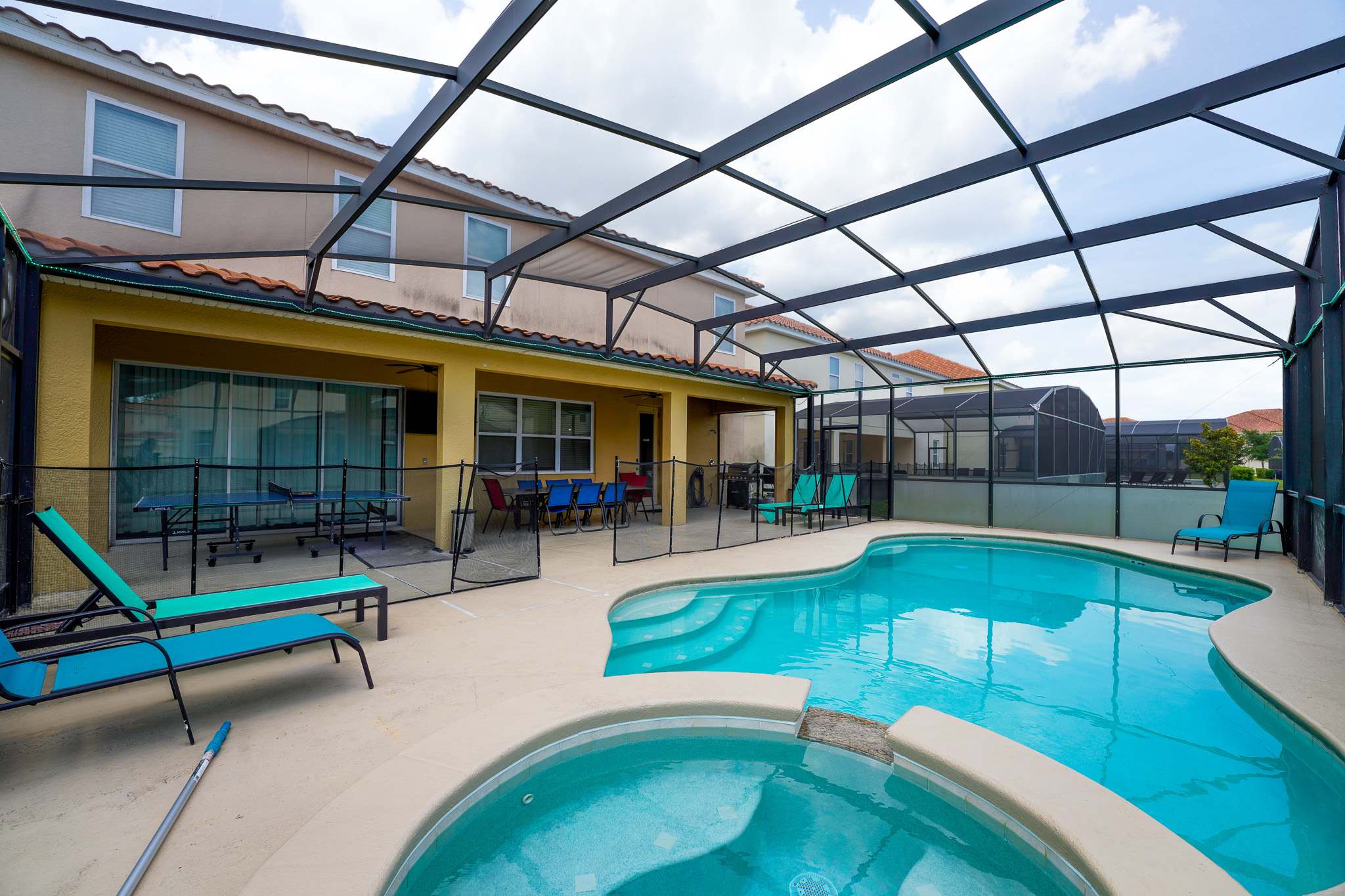 Relax in your private screened pool and hot tub oasis, complete with a spacious patio and vibrant dining area.