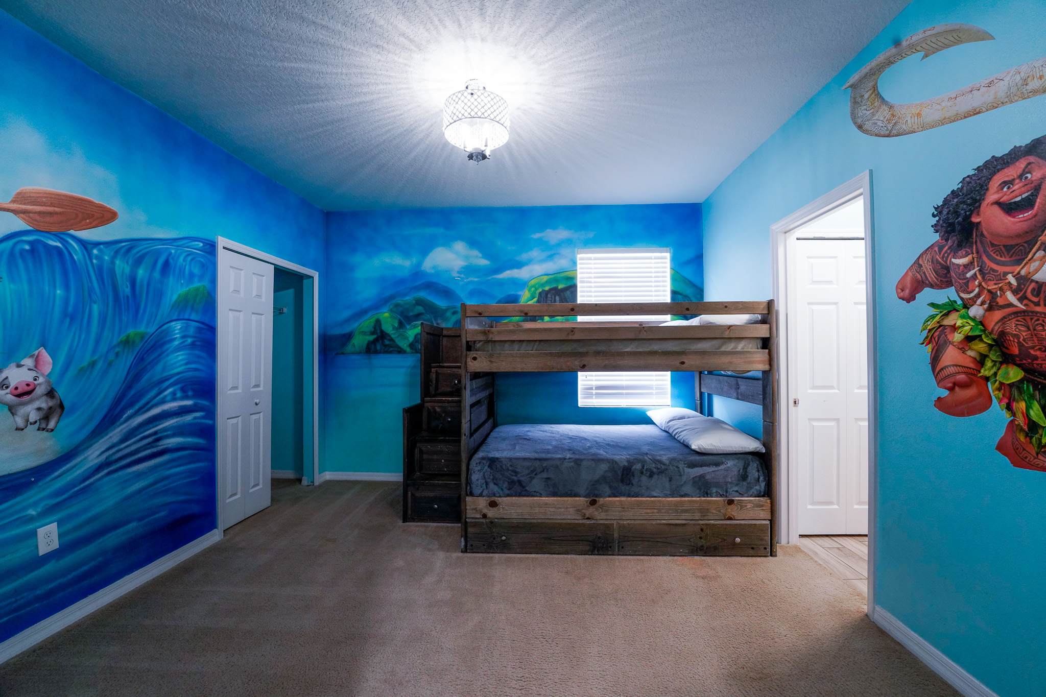 Dive into adventure in this ocean-themed room with vibrant murals and cozy bunk beds, perfect for kids!