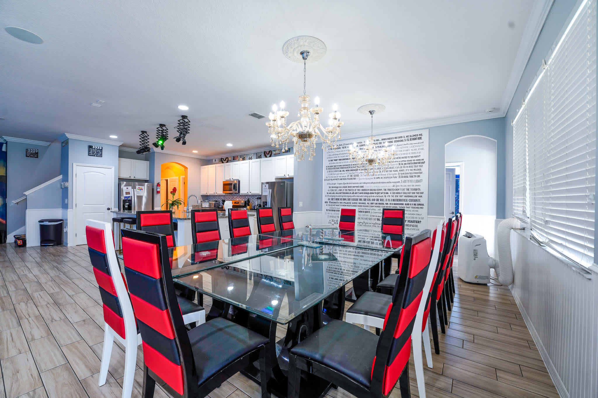 Host memorable dinners in this elegant dining room with seating for 12, featuring chic chandeliers and modern decor.