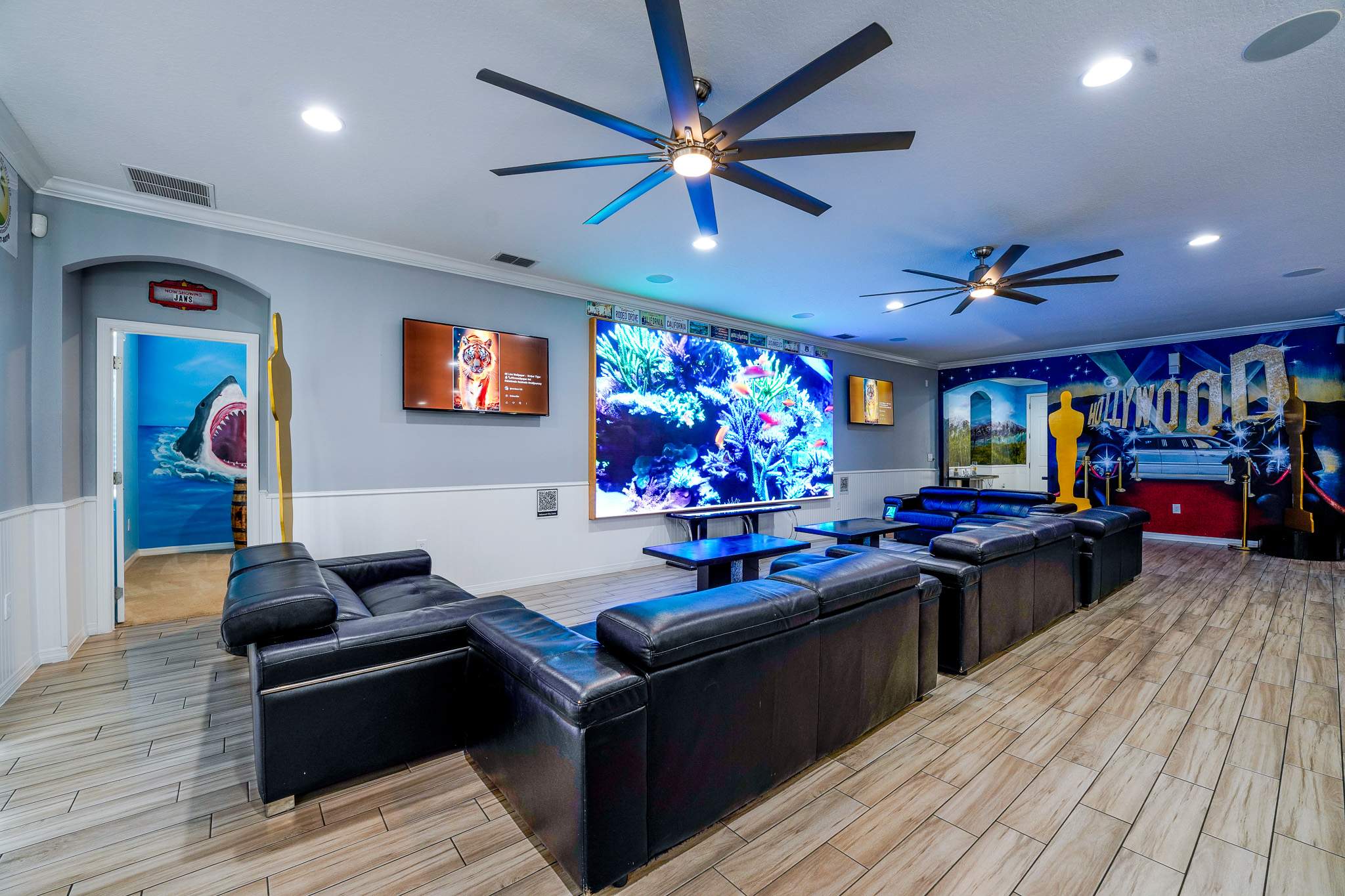 Experience movie nights in style with this Hollywood-themed game room, complete with plush seating and a massive screen for ultimate entertainment.