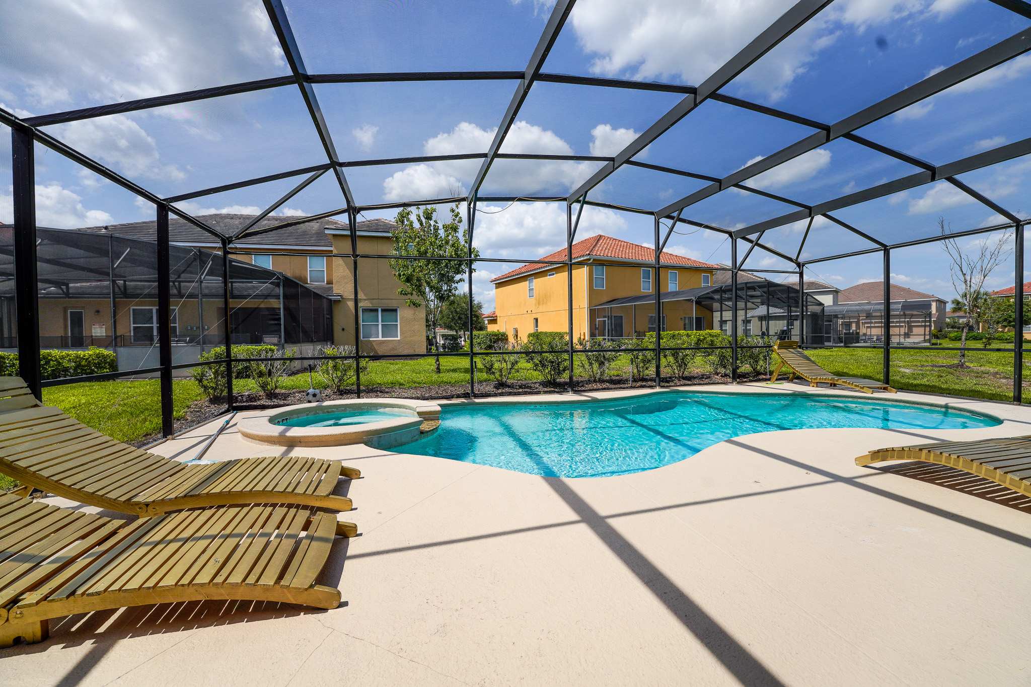 Relax in your private screened-in pool and hot tub, perfect for unwinding under the sunny skies.