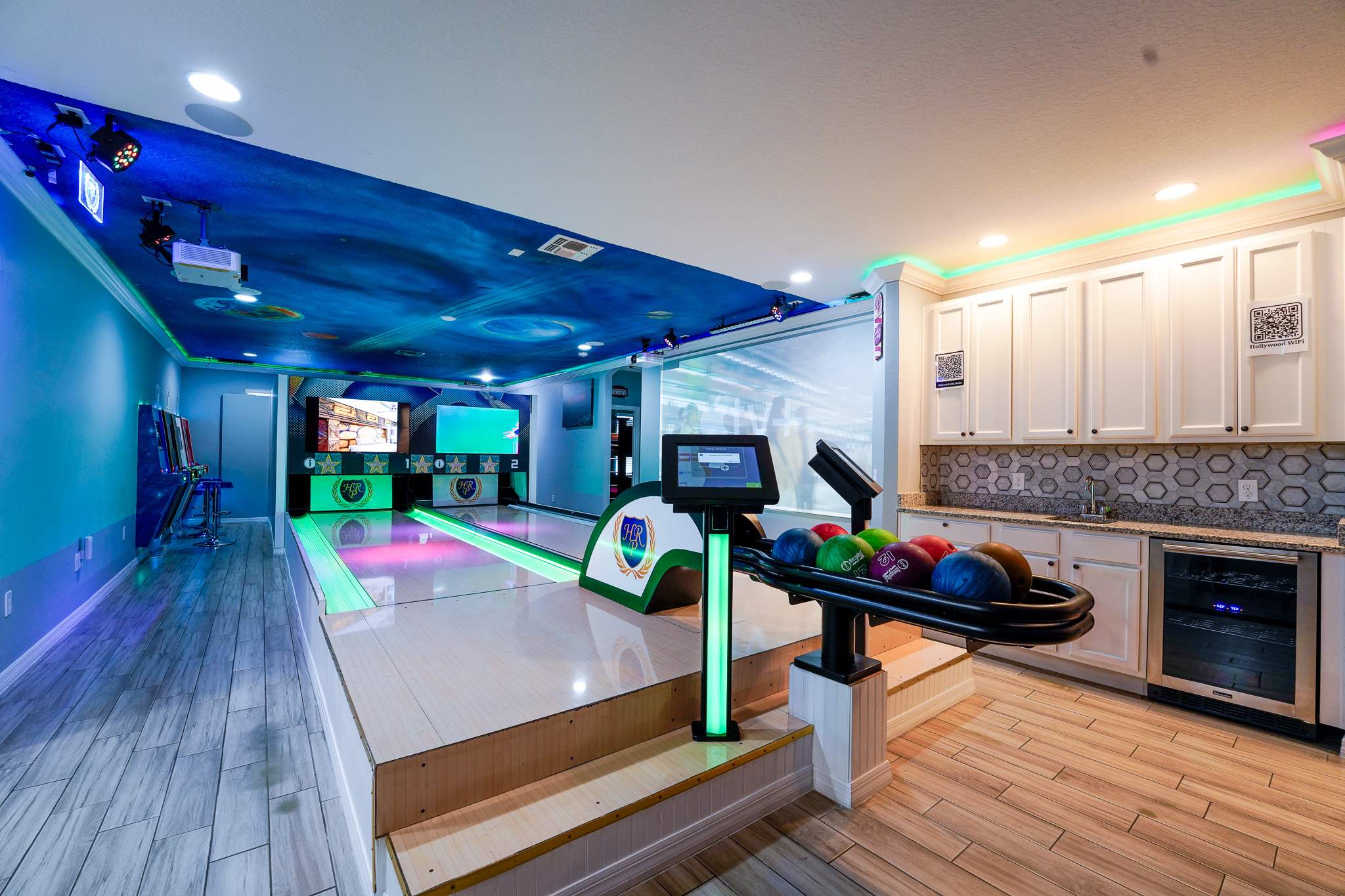 Enjoy a private bowling alley with vibrant lighting and a convenient kitchenette for ultimate fun and relaxation.