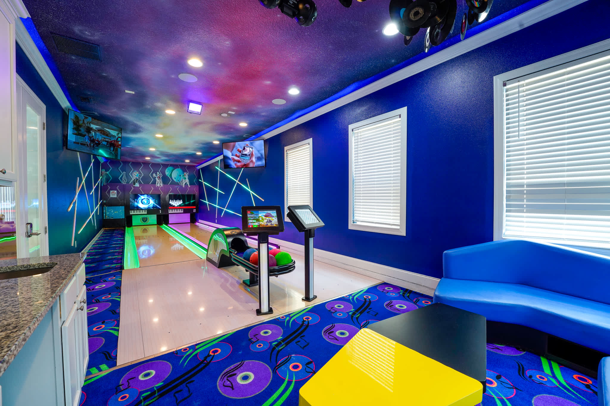 Enjoy a cosmic bowling experience in your private game room, complete with vibrant lighting and fun decor.