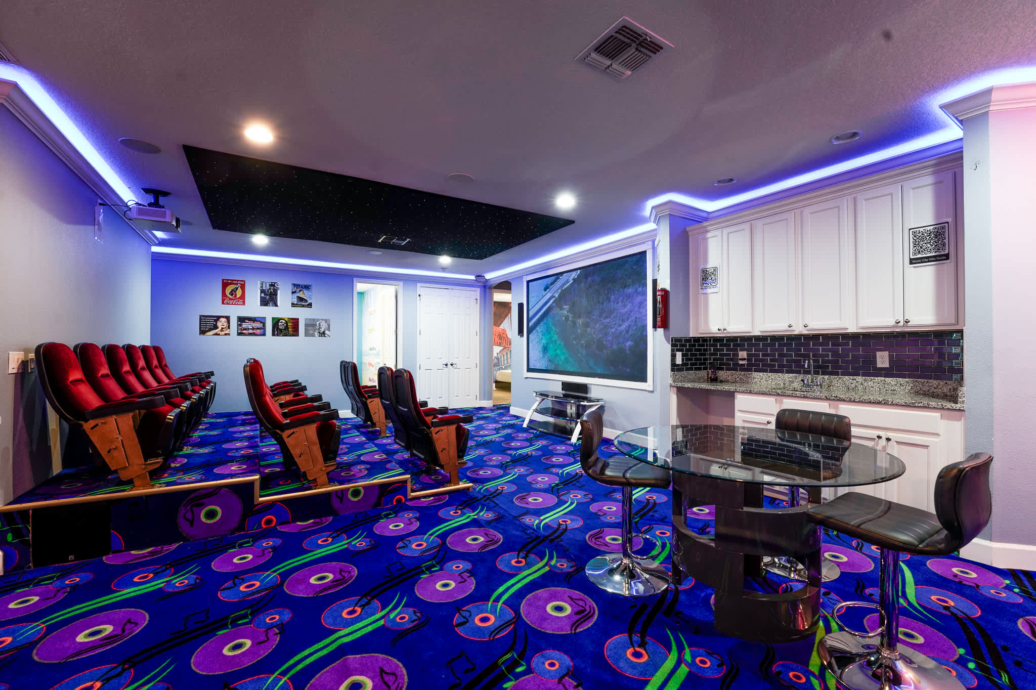 Experience movie magic in your private theater room with plush seating, vibrant decor, and a starry ceiling for unforgettable entertainment nights.