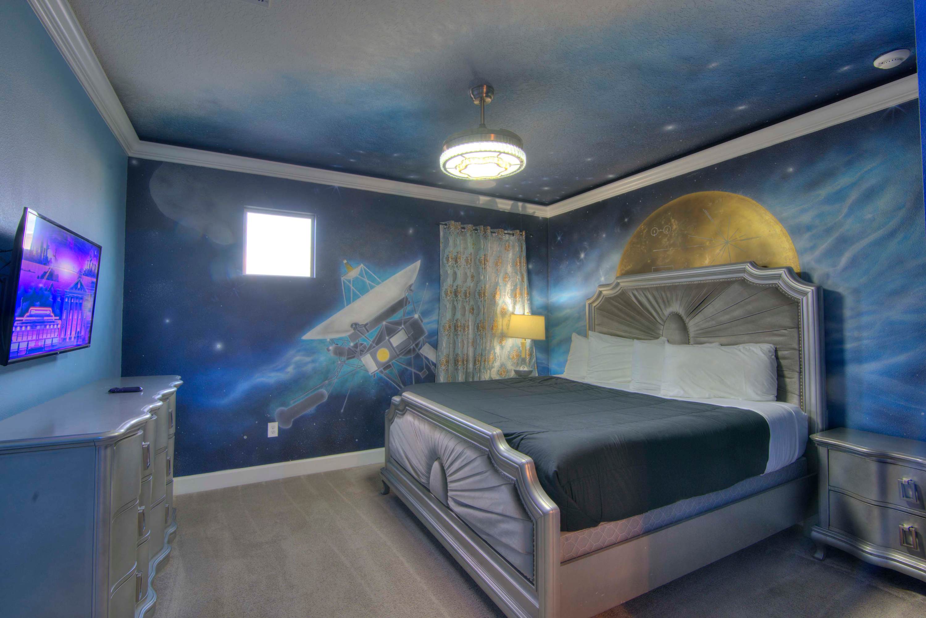 Explore the universe from your bed in this space-themed room, complete with cosmic murals and modern amenities.