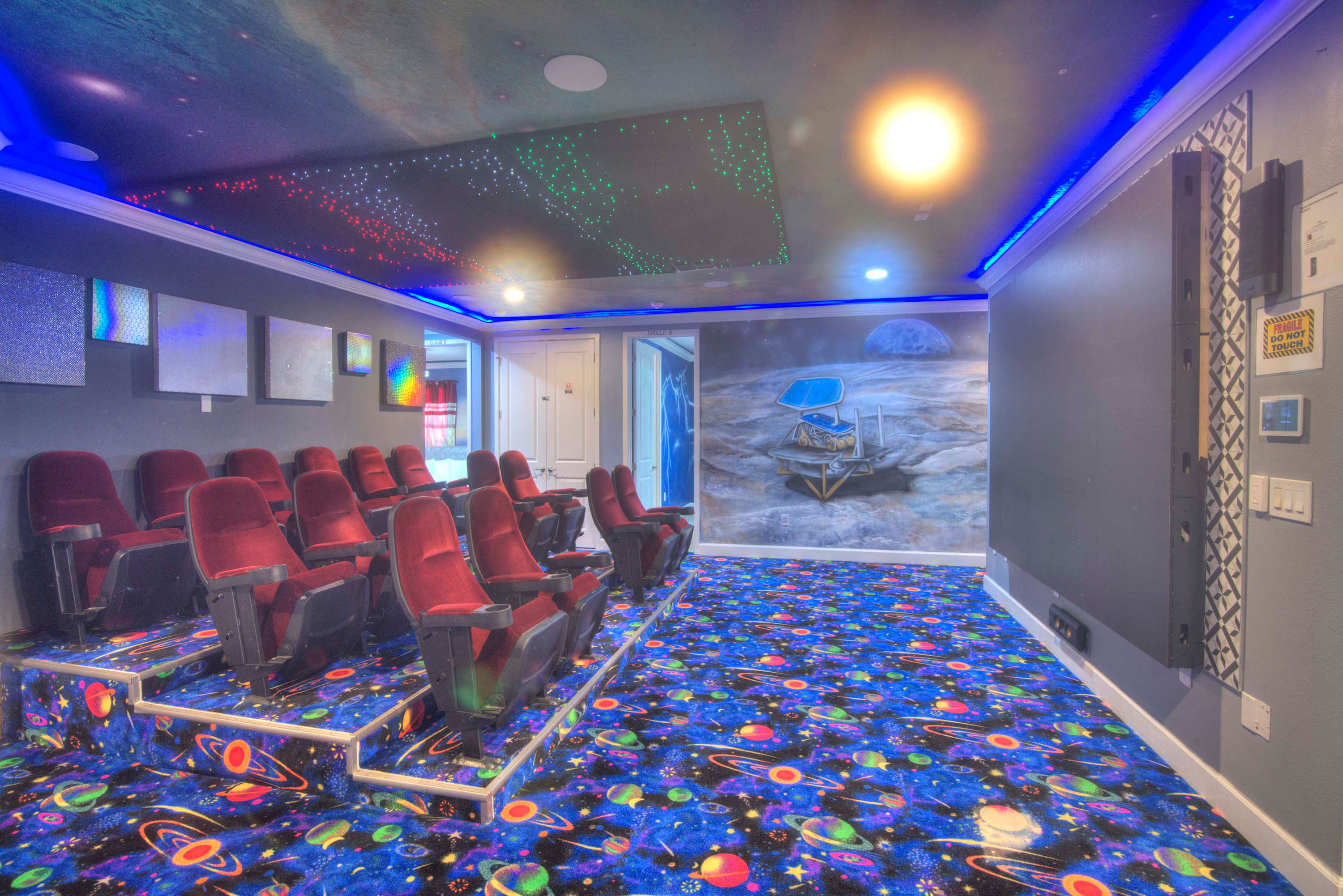 Experience cinematic magic in your private space-themed home theater, perfect for movie nights with family and friends.