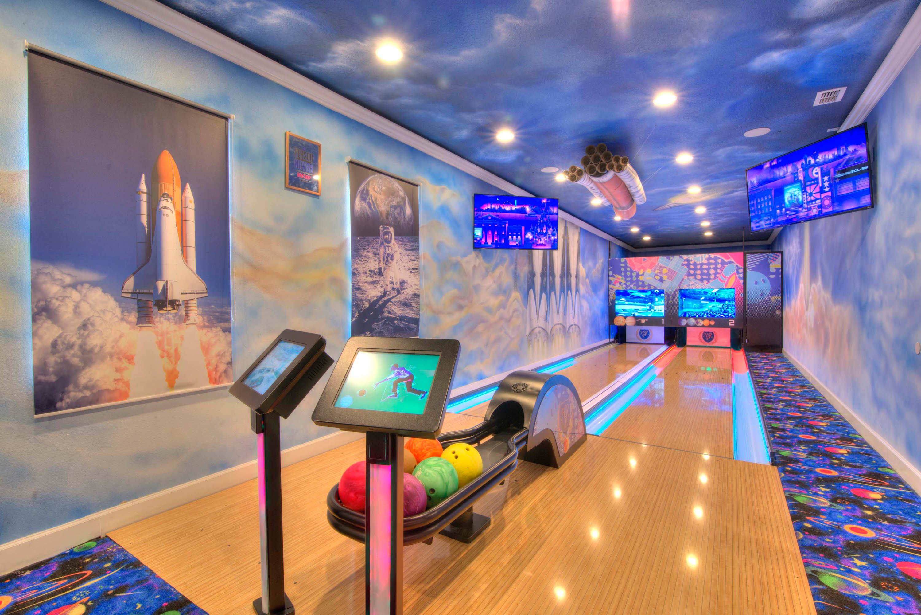 Enjoy a cosmic bowling experience in this space-themed private game room, perfect for family fun and entertainment.