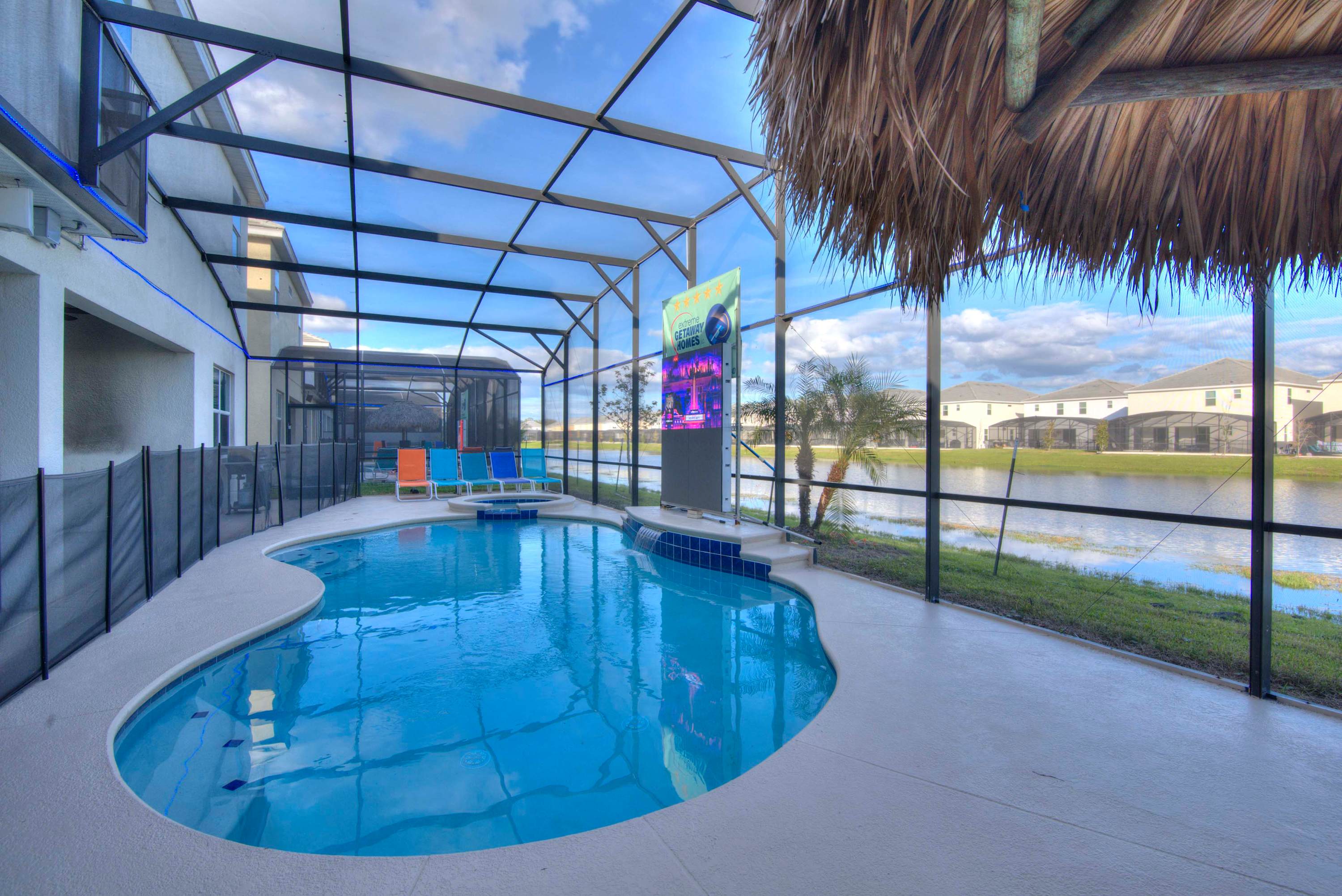 Relax by the private pool with serene pond views and vibrant seating, perfect for unwinding in style.