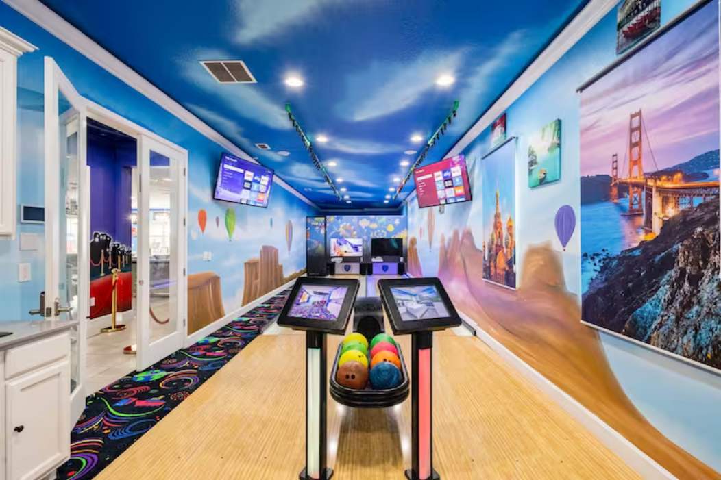 Enjoy endless fun in this vibrant game room featuring a mini bowling alley and colorful murals, perfect for all ages.