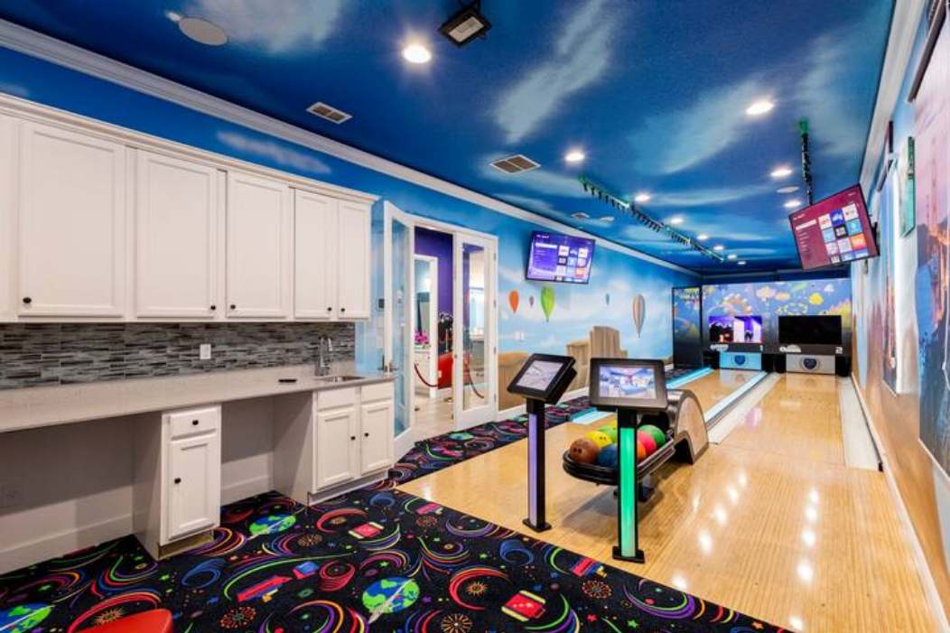Enjoy your private bowling alley with vibrant decor and modern amenities for endless fun!