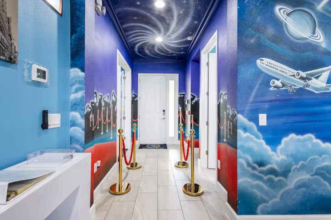 Step into a galaxy-themed hallway that transports you to another world with vibrant murals and celestial designs.