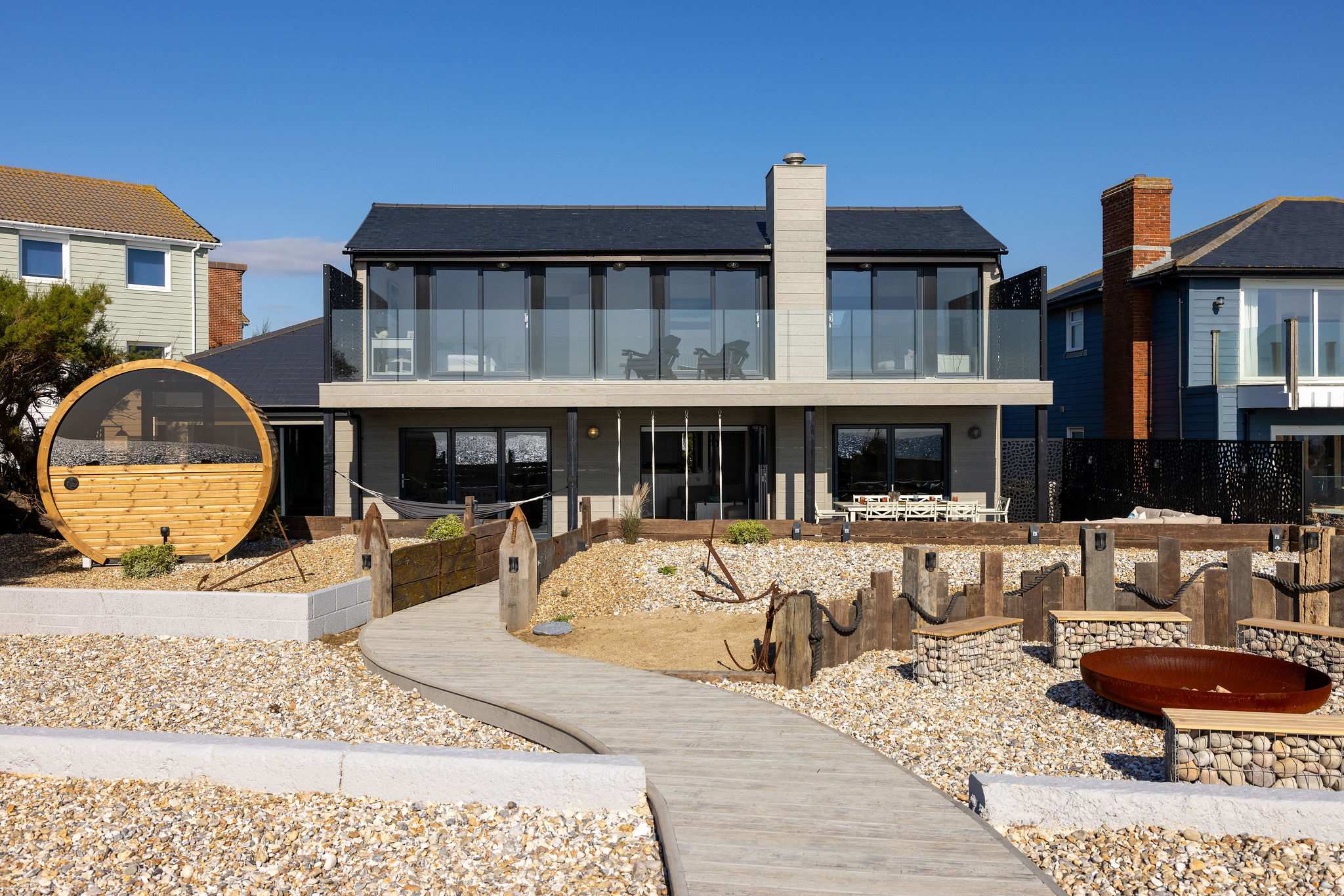 The newly renovated seafront garden features a fire pit, seating area, decking, swings and cedar sauna.