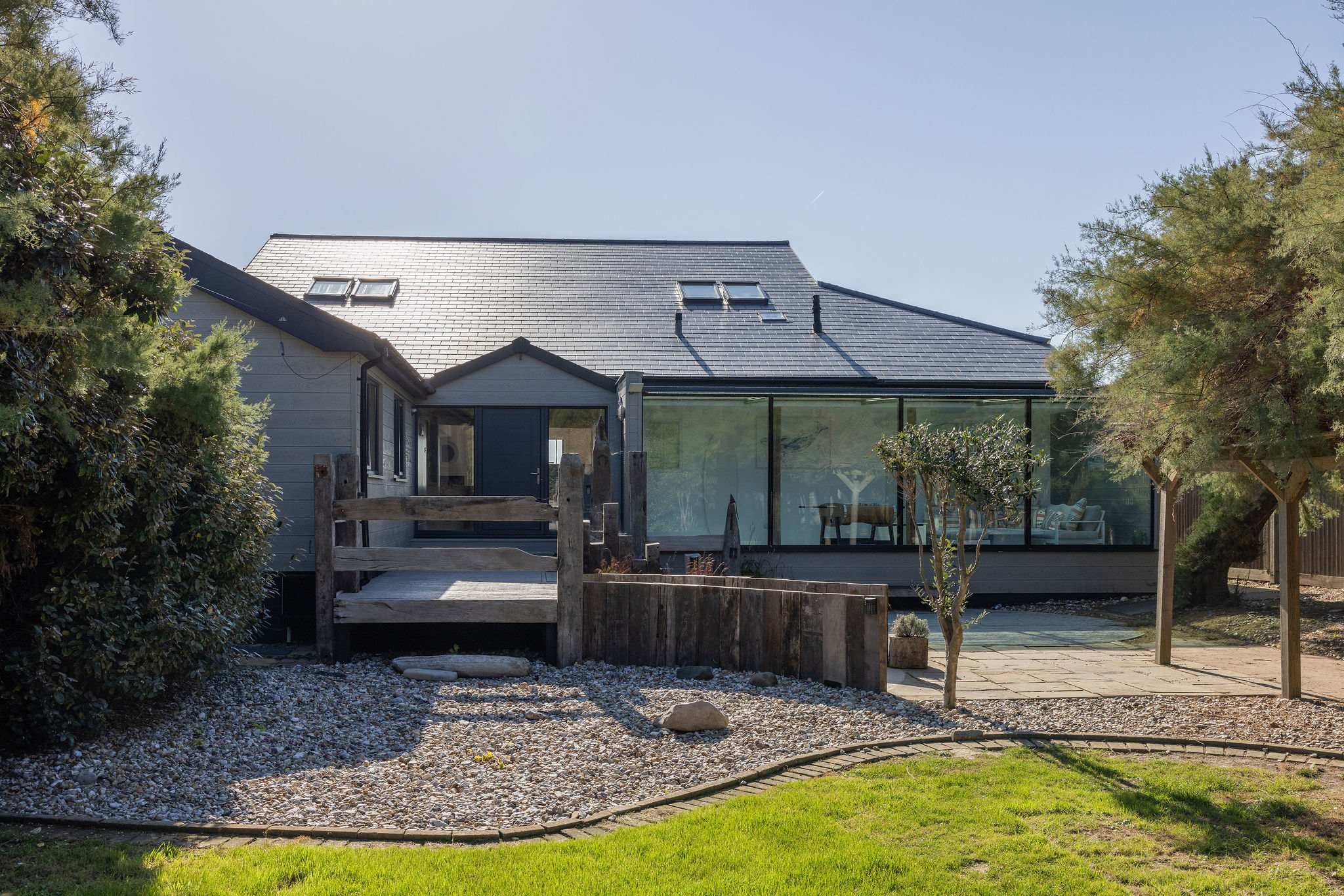 Once you park, enter the home via the landscaped front garden, lined with tamarisk trees and shingle path.