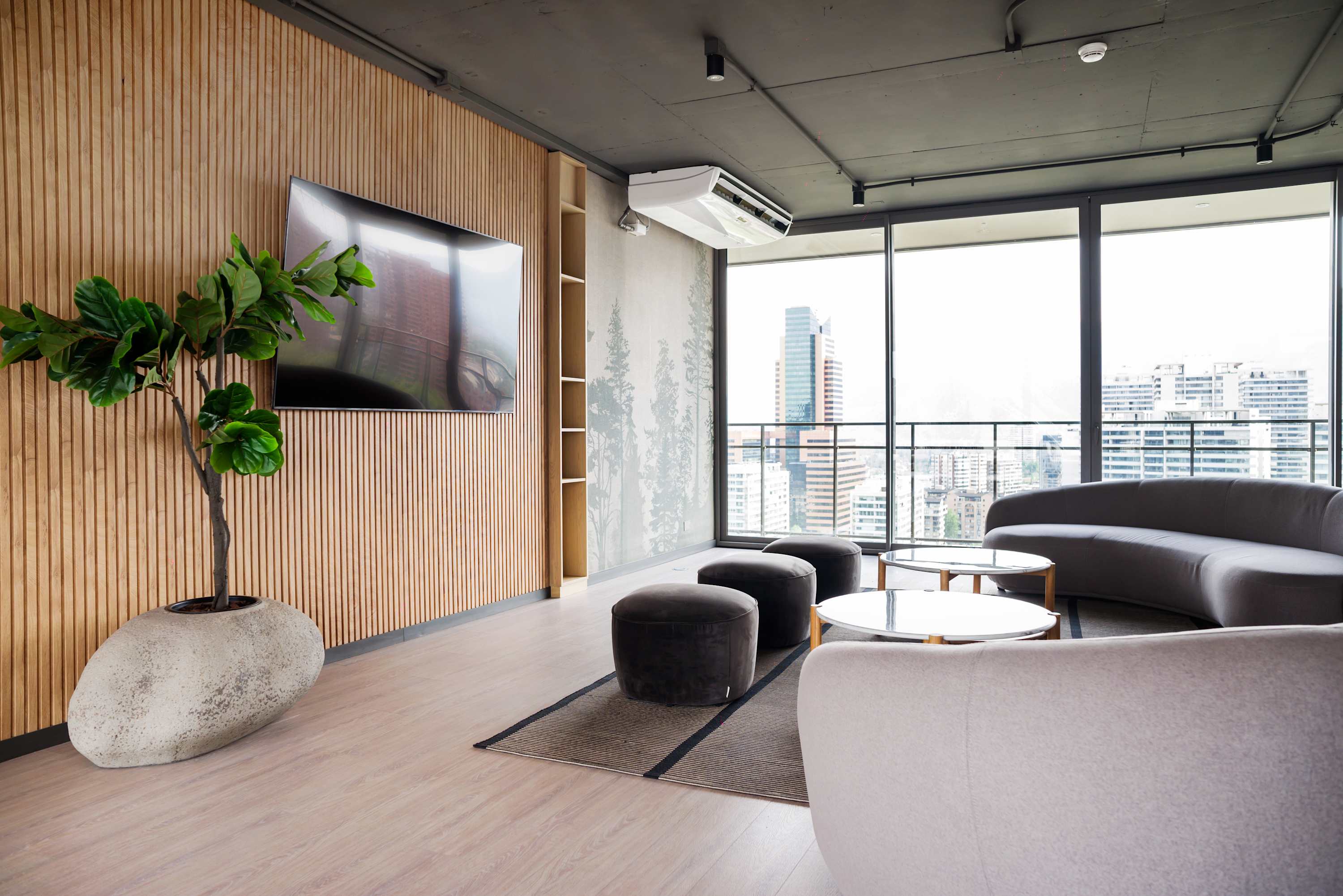 Enjoy panoramic city views from this stylish lounge with modern seating and entertainment options.