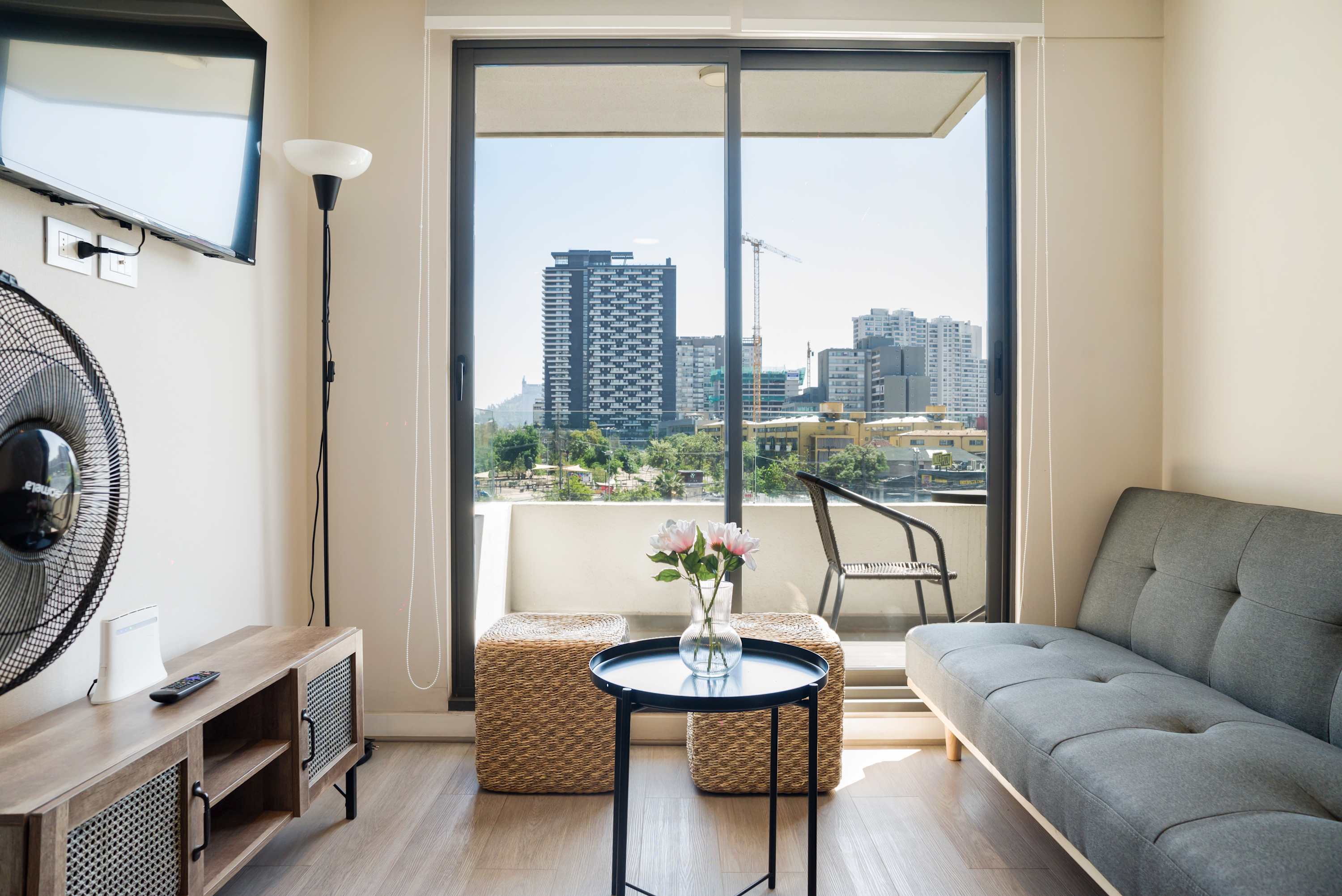 Bright living area with stunning city views, ideal for relaxation and unwinding.