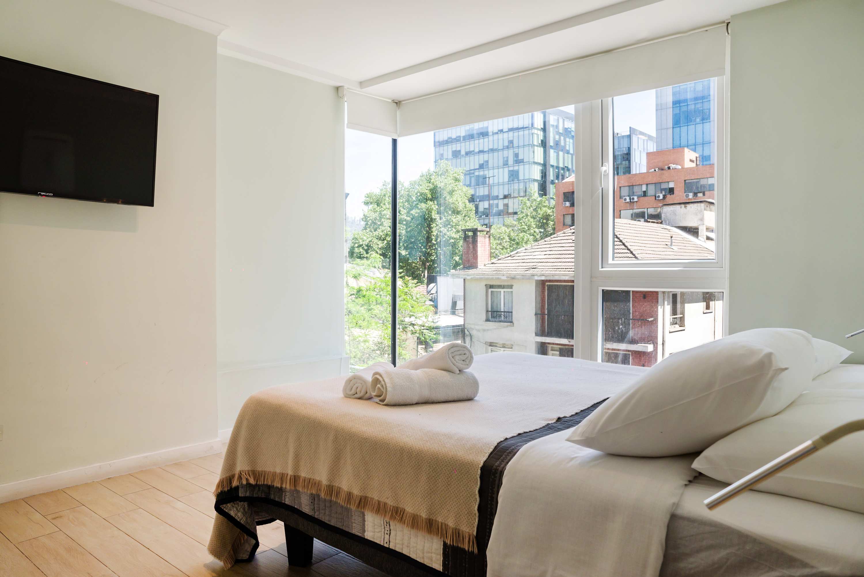 Relax in this bright bedroom with stunning city views and modern amenities.
