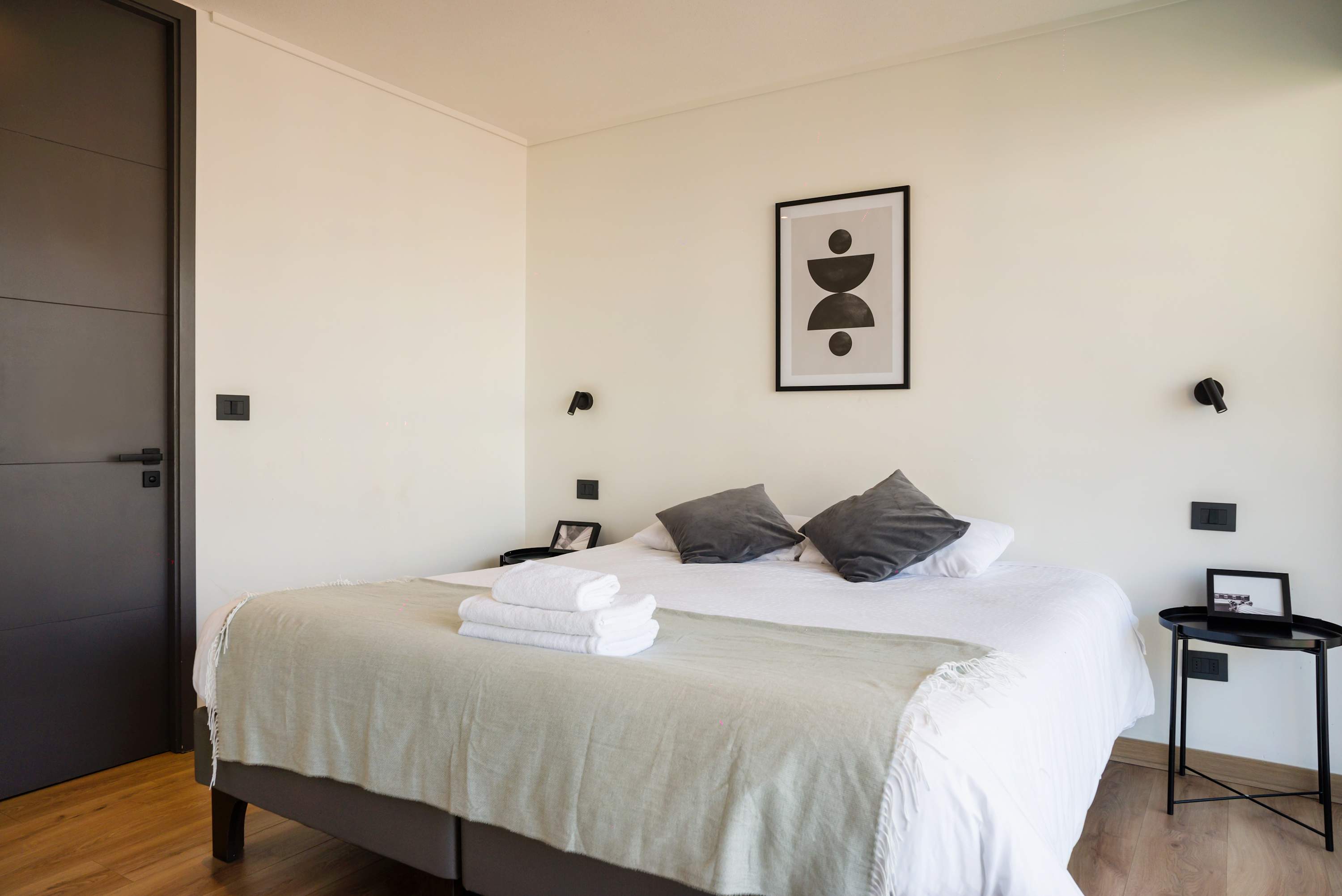 Relax in this serene bedroom with minimalist decor and natural light, perfect for unwinding after a day of exploring.