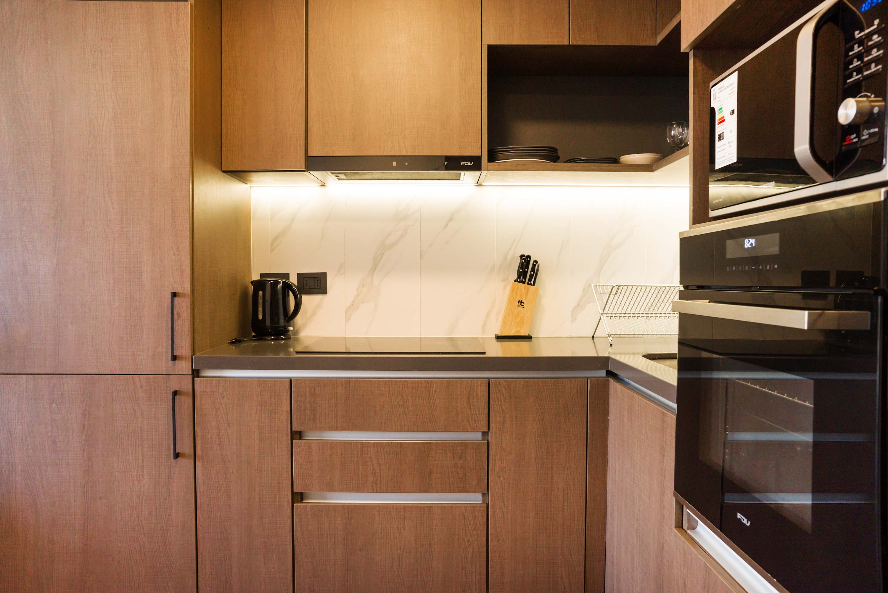 Sleek and modern kitchen with all essentials for a comfortable stay, perfect for cooking your favorite meals.