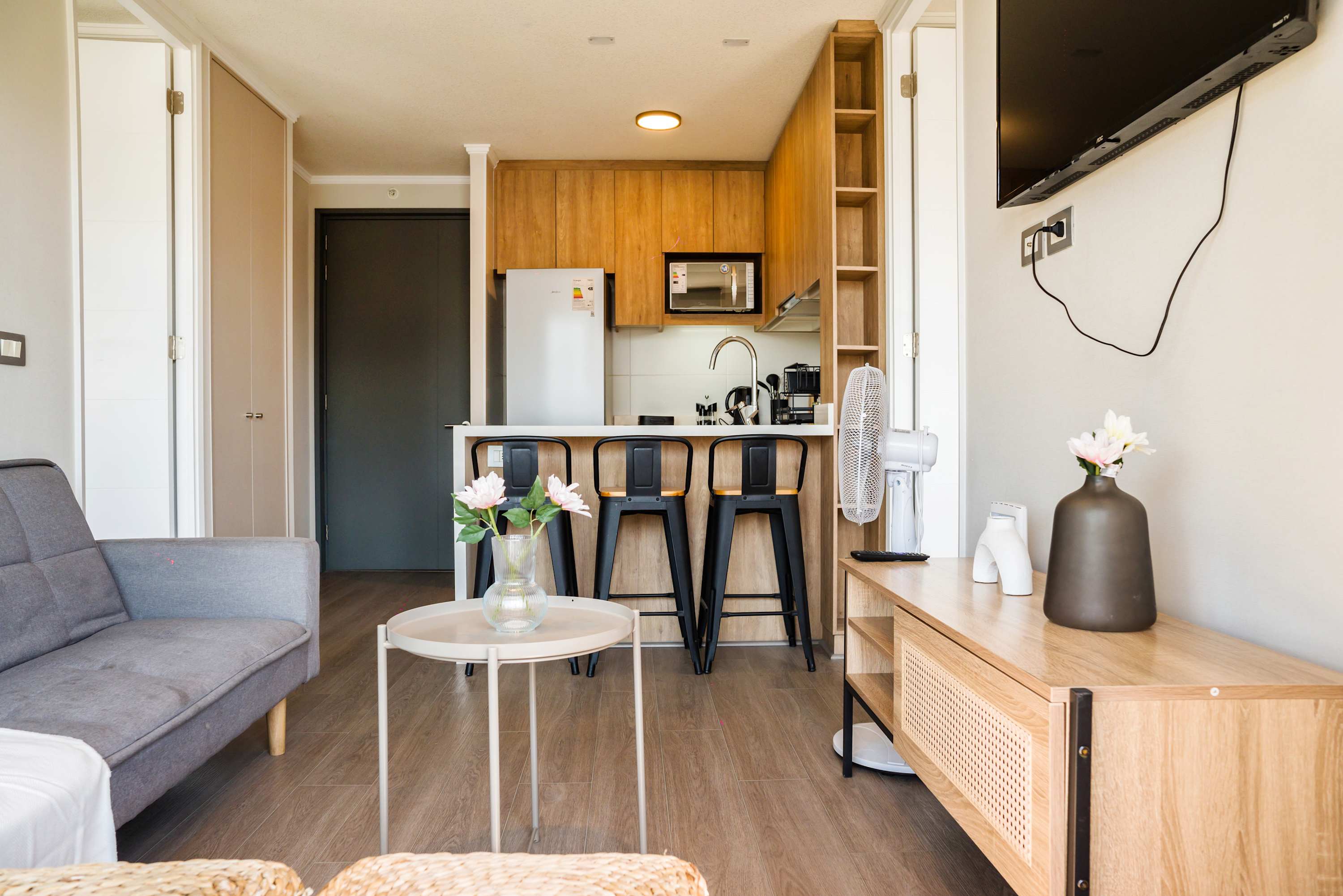 Cozy living area with modern kitchen and stylish decor, perfect for relaxing after exploring the city.